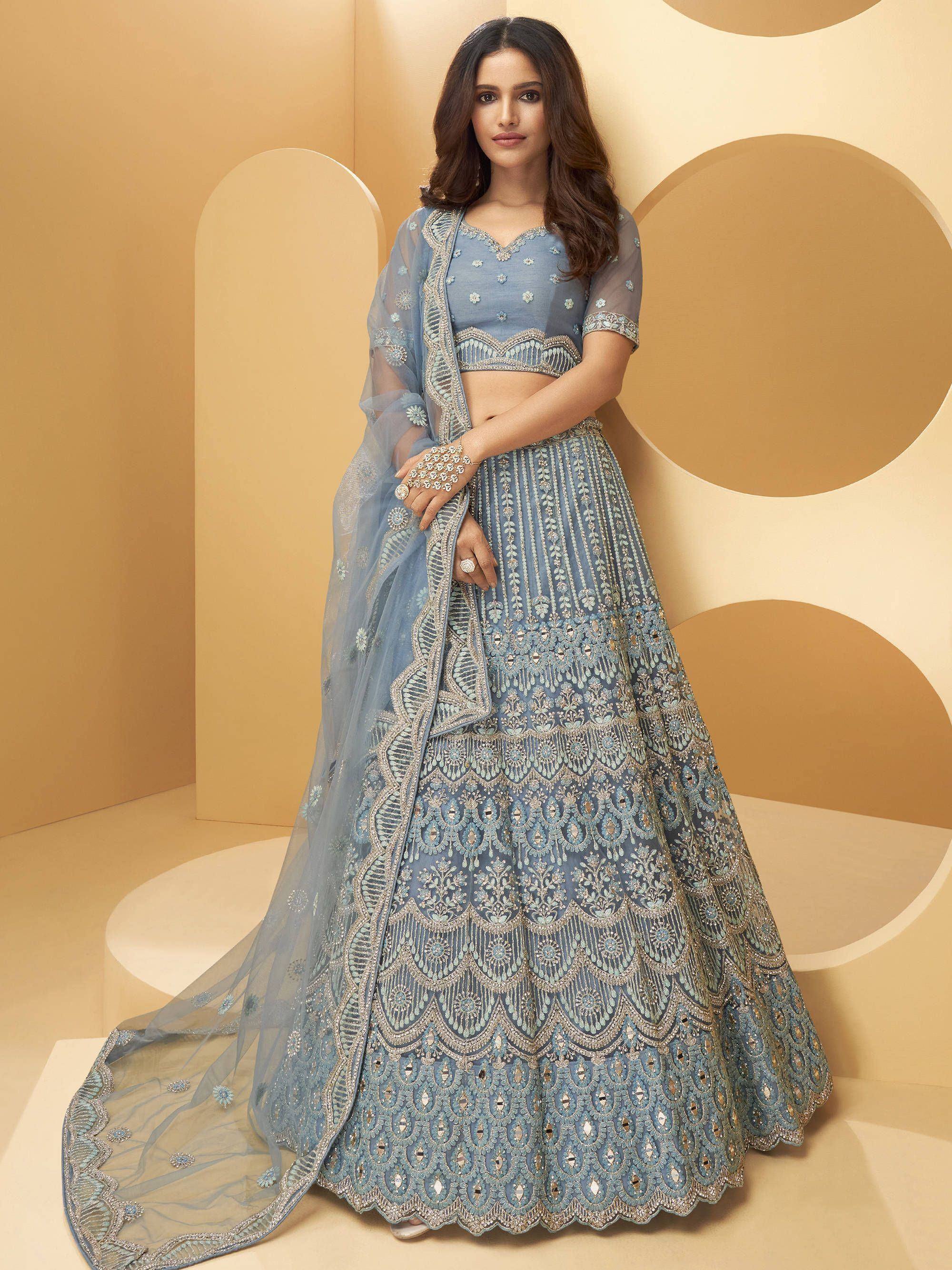 Elegant blue embroidered lehenga choli with intricate detailing and sheer dupatta for Indian ethnic wear
