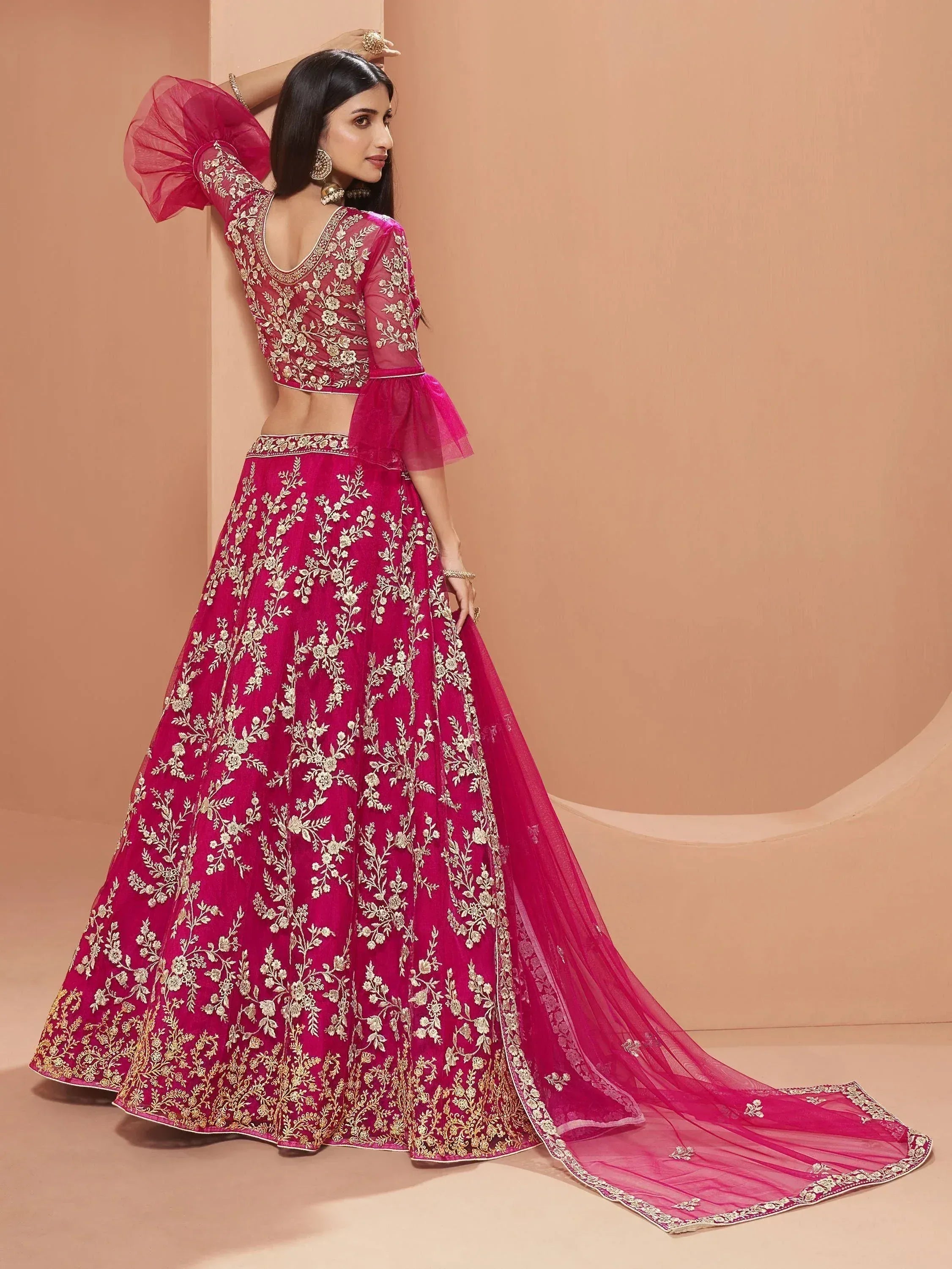 Pink embroidered lehenga choli with floral gold work, puff sleeves, and long train for Indian ethnic wear