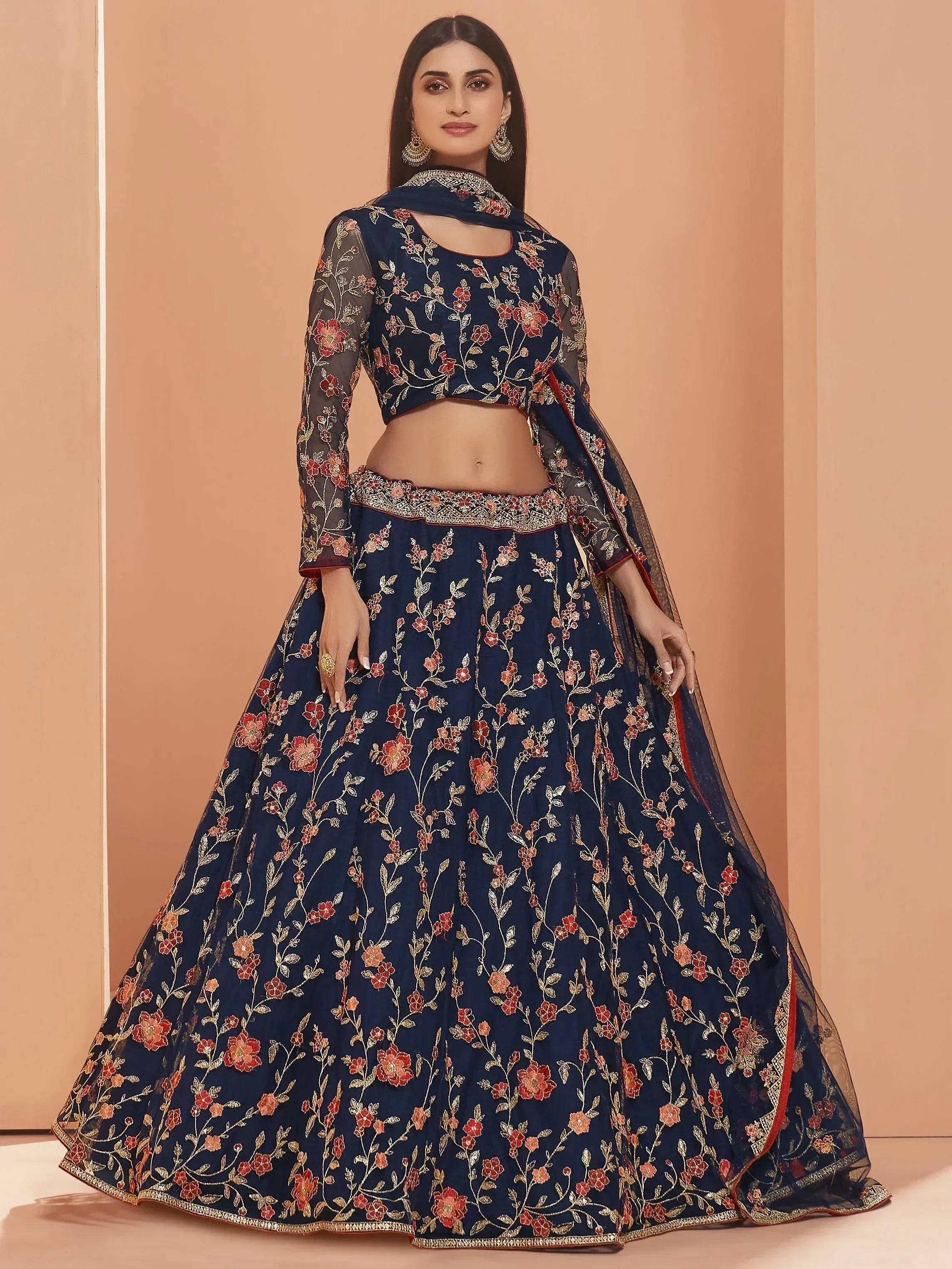 Navy blue embroidered lehenga choli with floral motifs and sheer sleeves, perfect for Indian ethnic wear occasions.