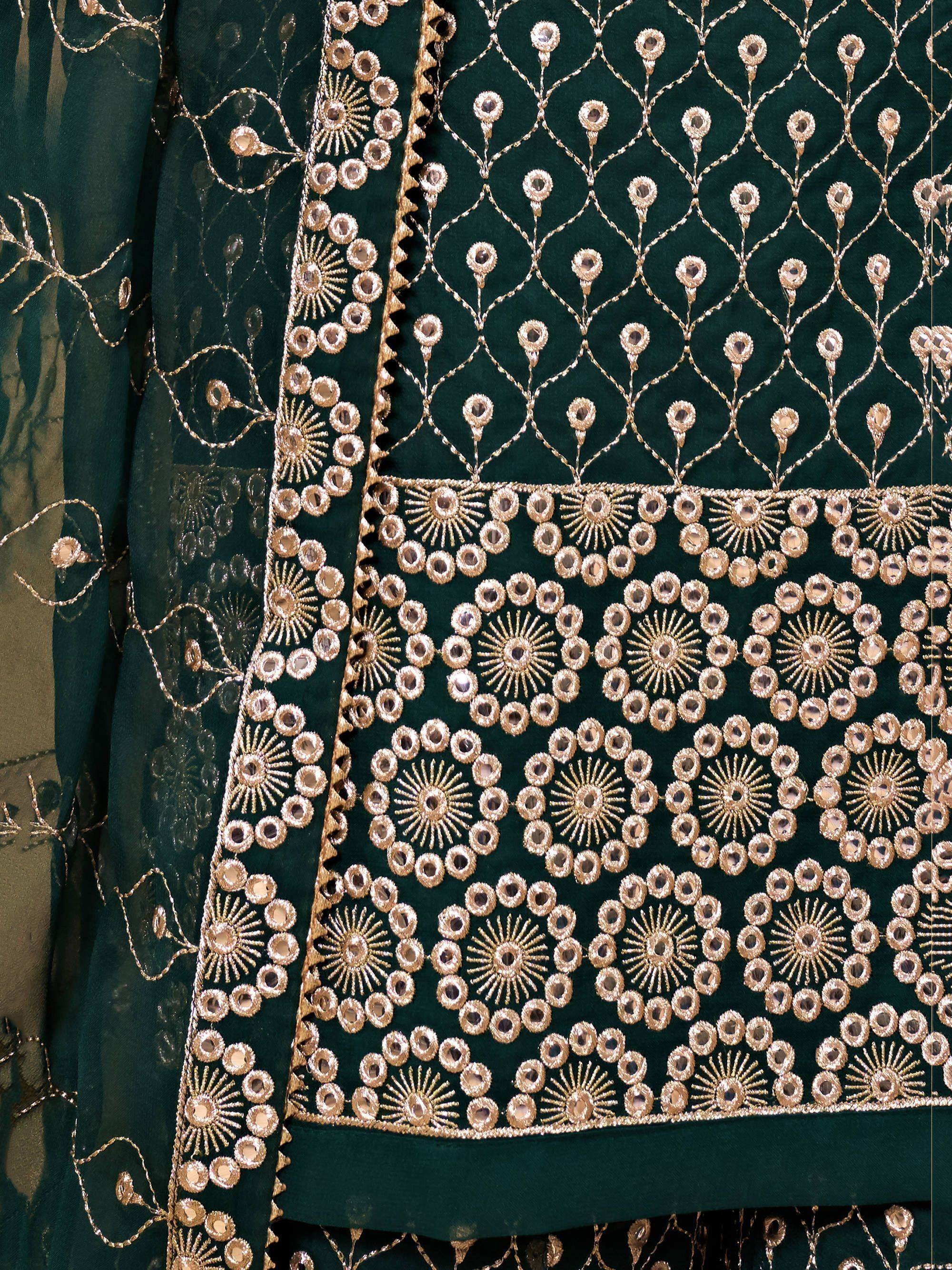 Dark green ethnic fabric with intricate gold embroidery and floral patterns