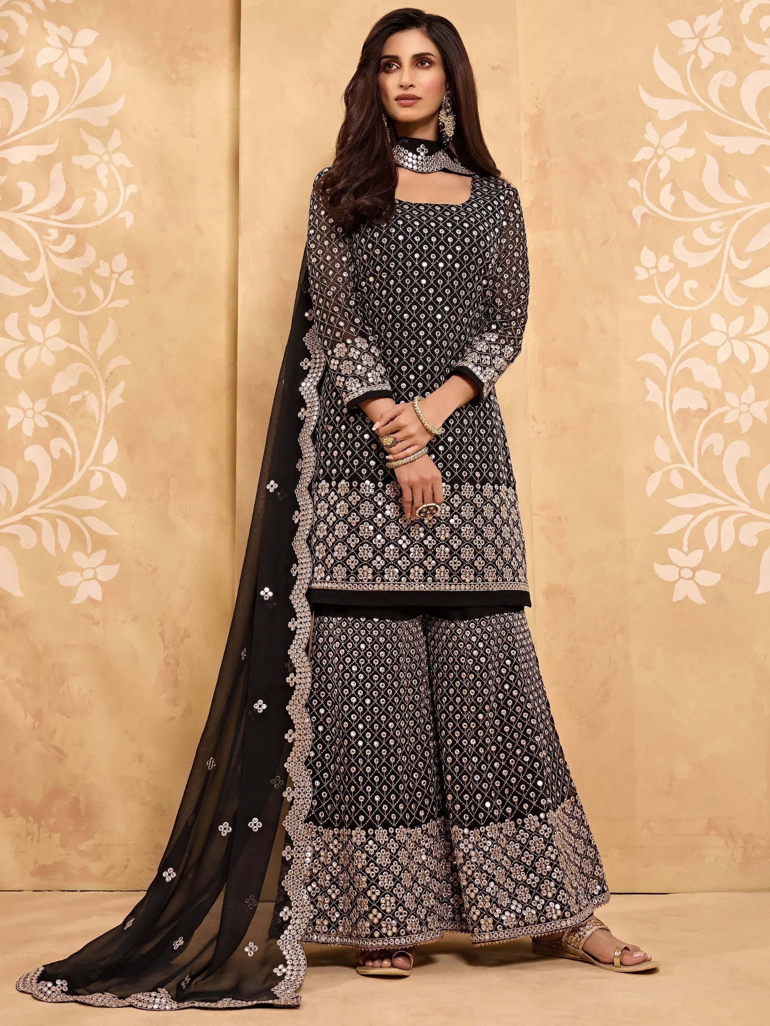 Woman wearing black embroidered palazzo salwar kameez with matching dupatta