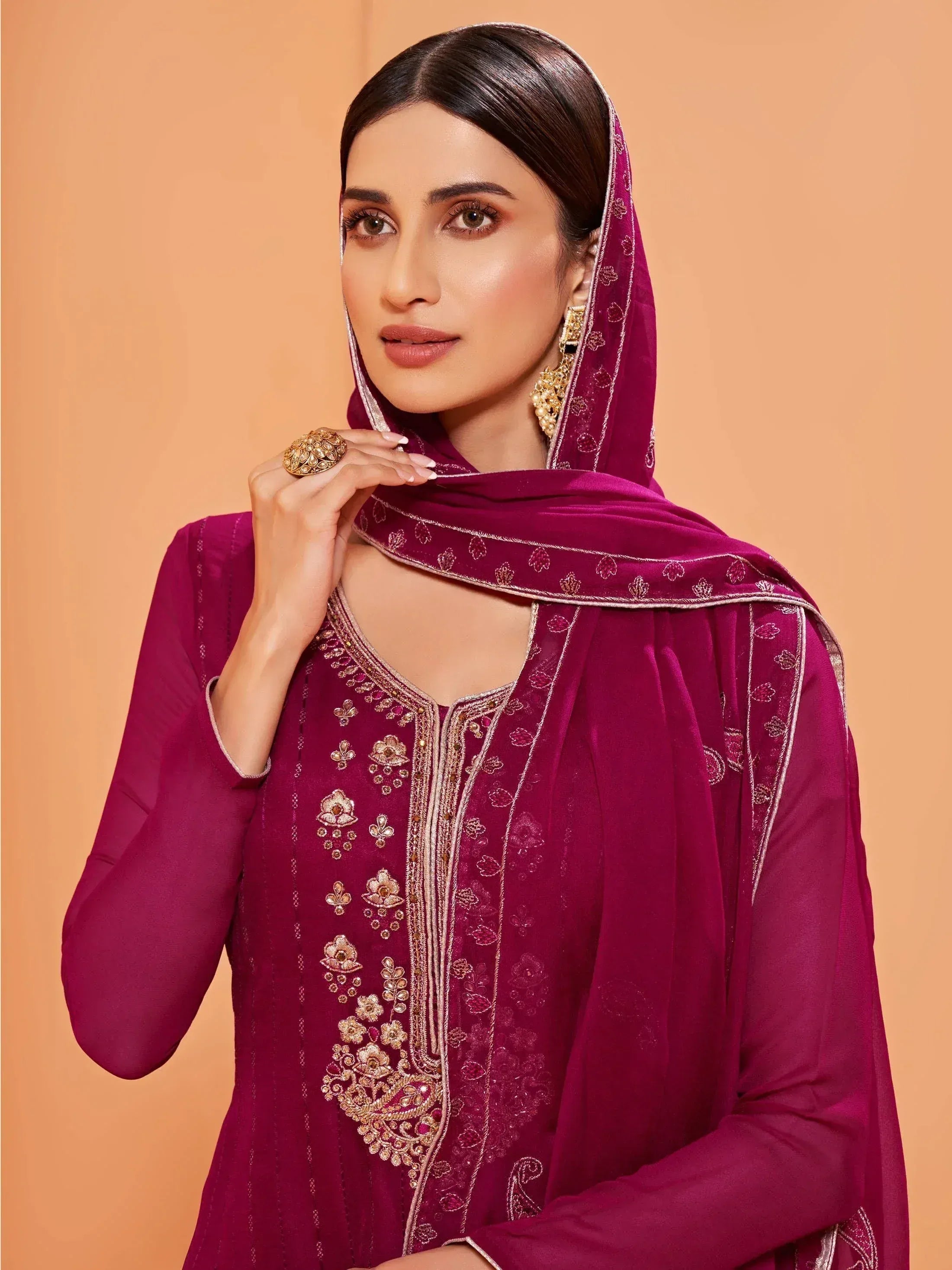 Elegant maroon salwar kameez with gold embroidery and matching dupatta, perfect for Indian ethnic wear occasions.