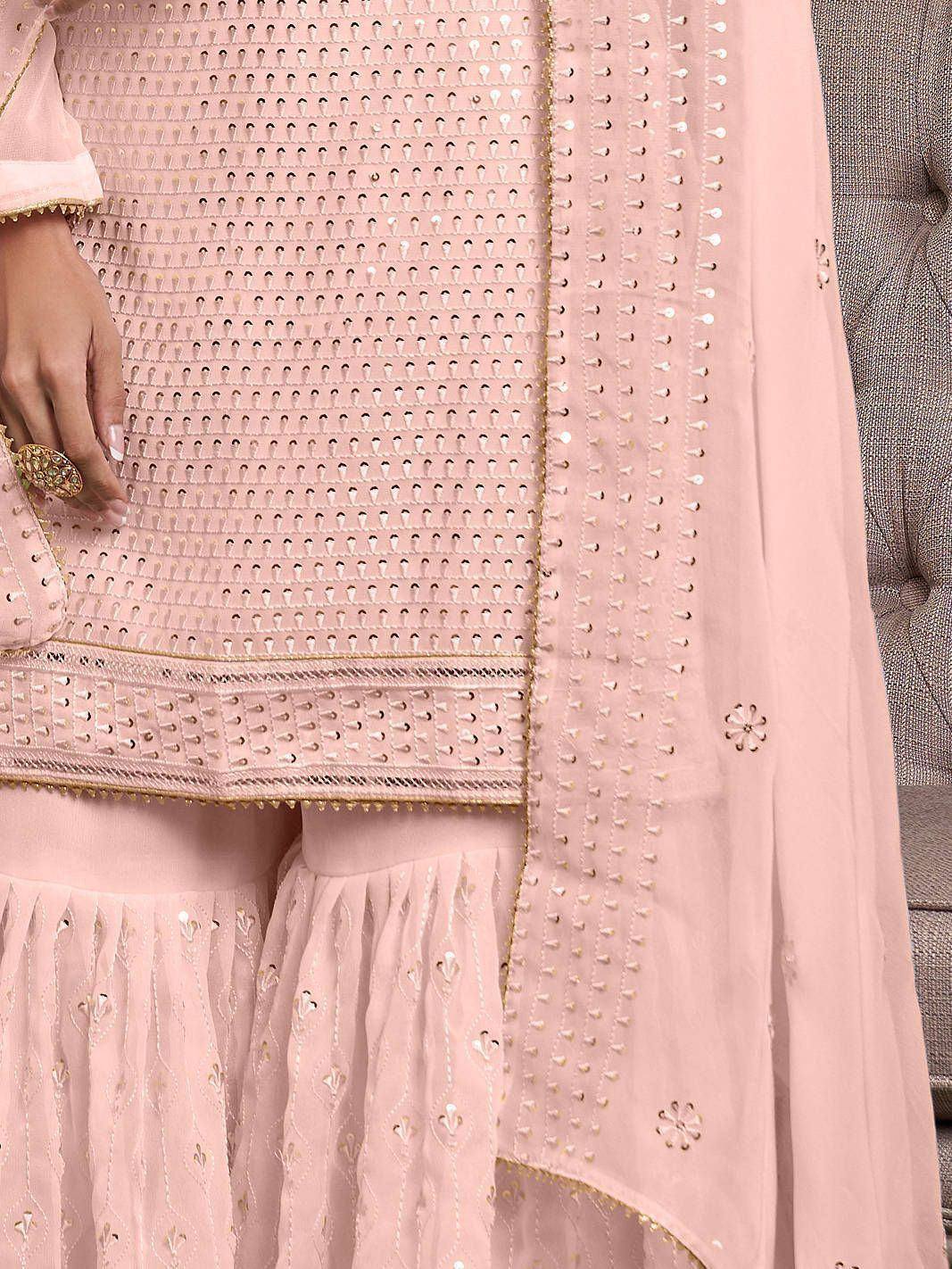 Light pink ethnic salwar kameez with mirror work and gold embroidery details