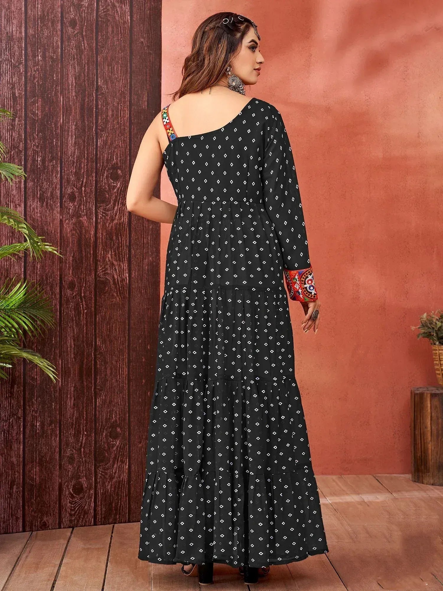 Black ethnic gown with white diamond print and colorful embroidered sleeves, perfect for Indian wear.