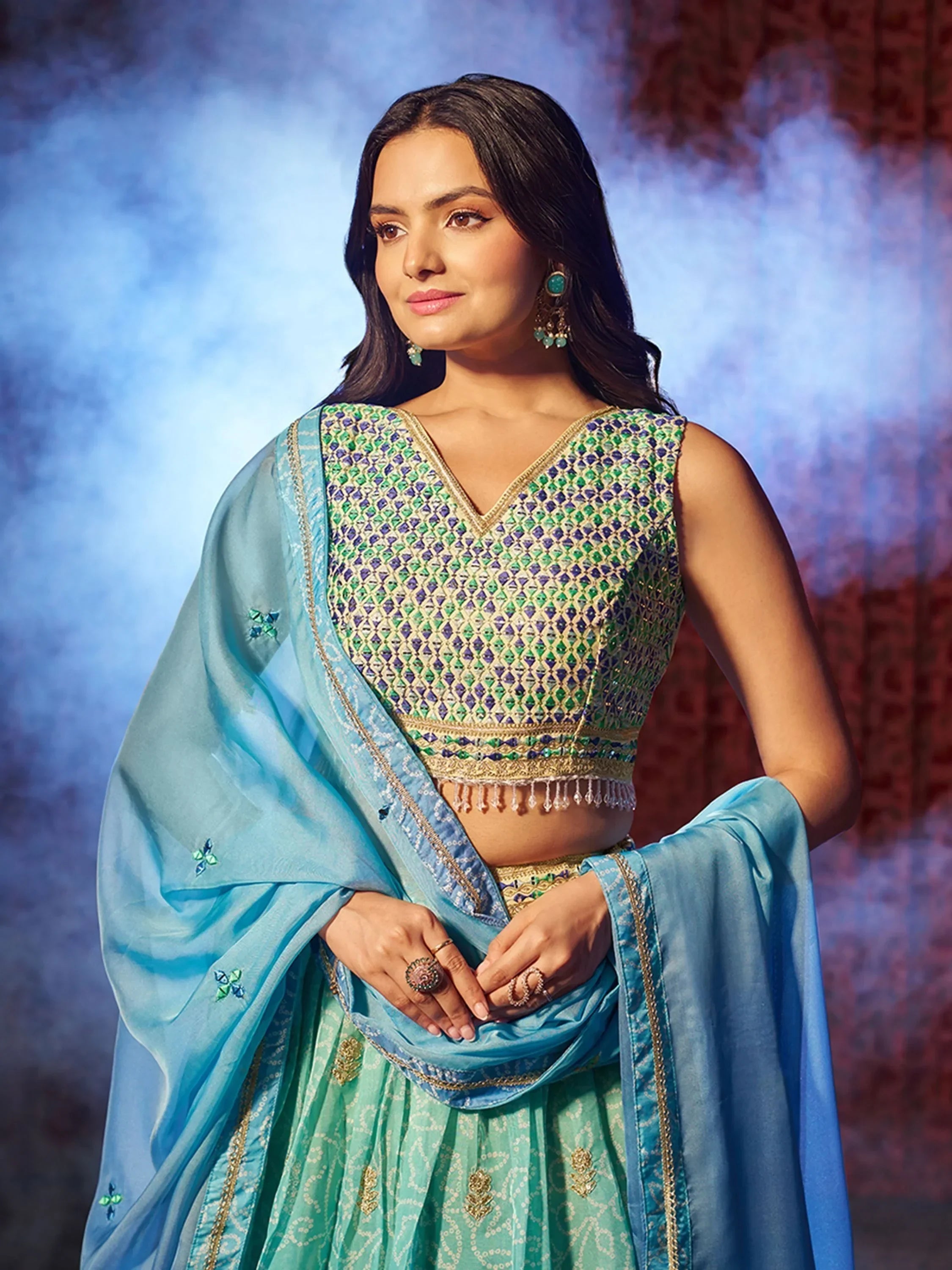 Woman in blue and green embroidered lehenga choli with dupatta, Indian ethnic wear