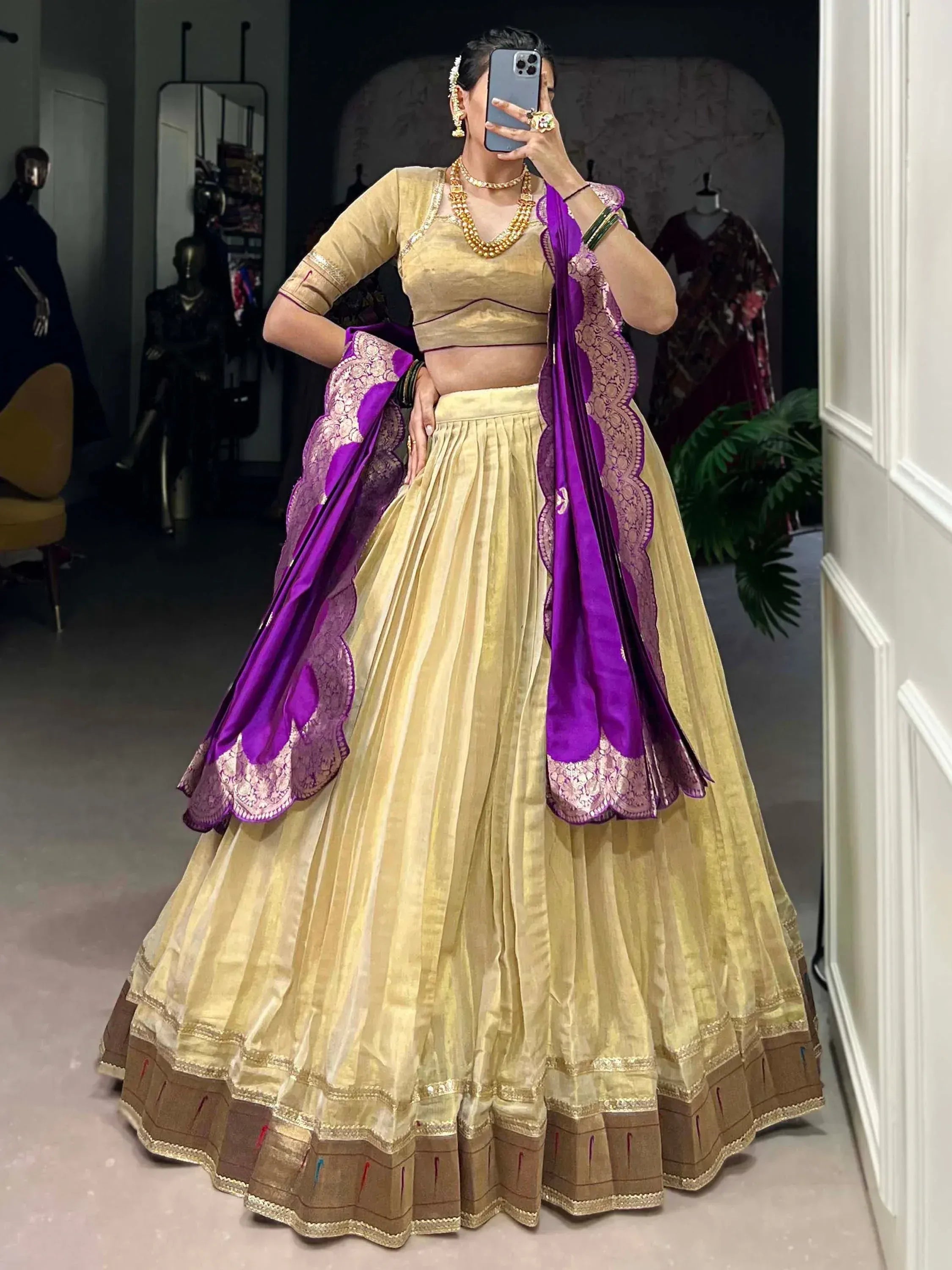Golden lehenga choli with purple dupatta, perfect for Indian ethnic wear and festive occasions.