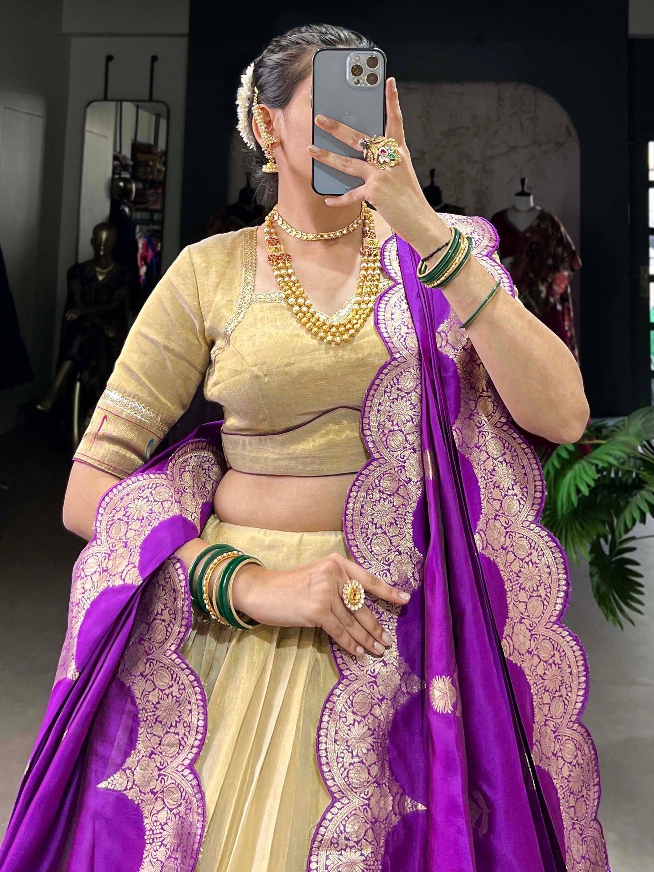 Woman in gold lehenga choli with purple dupatta, traditional Indian ethnic wear, designer jewelry