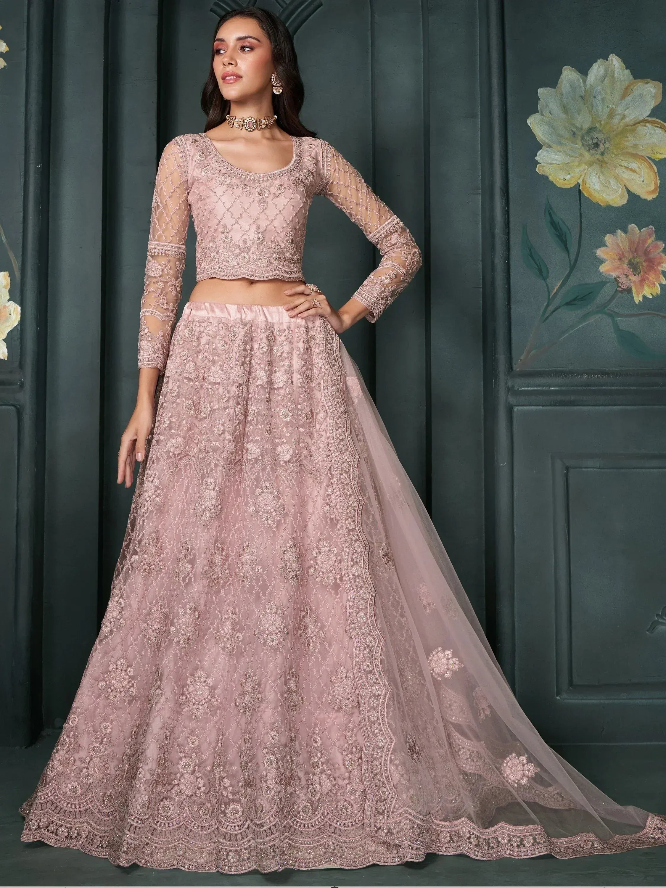 Dusty pink embroidered lehenga choli with sheer sleeves, perfect for Indian weddings and festive occasions.