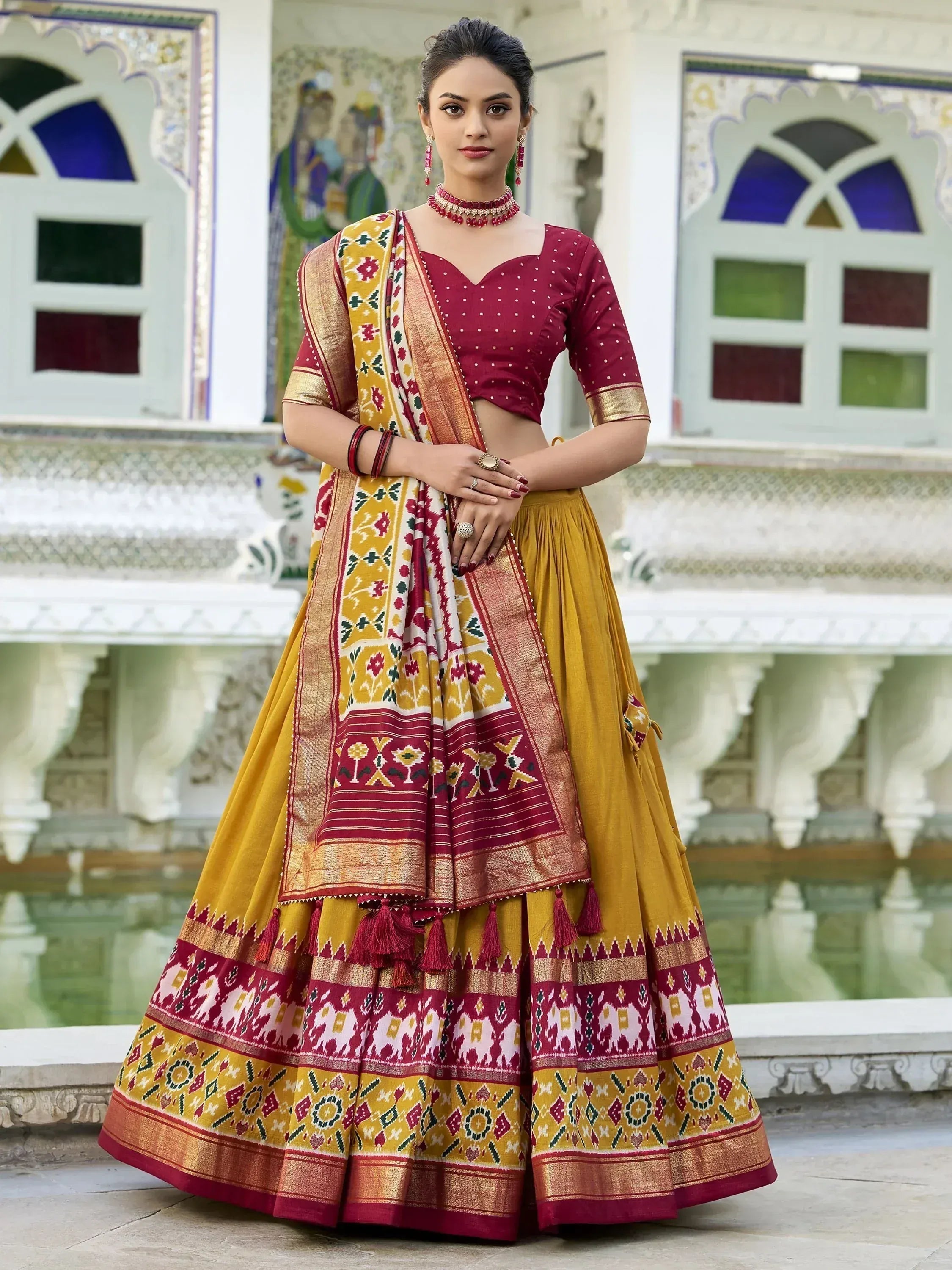Maroon and mustard designer lehenga choli with ikat print and tassels, perfect for Indian ethnic wear occasions