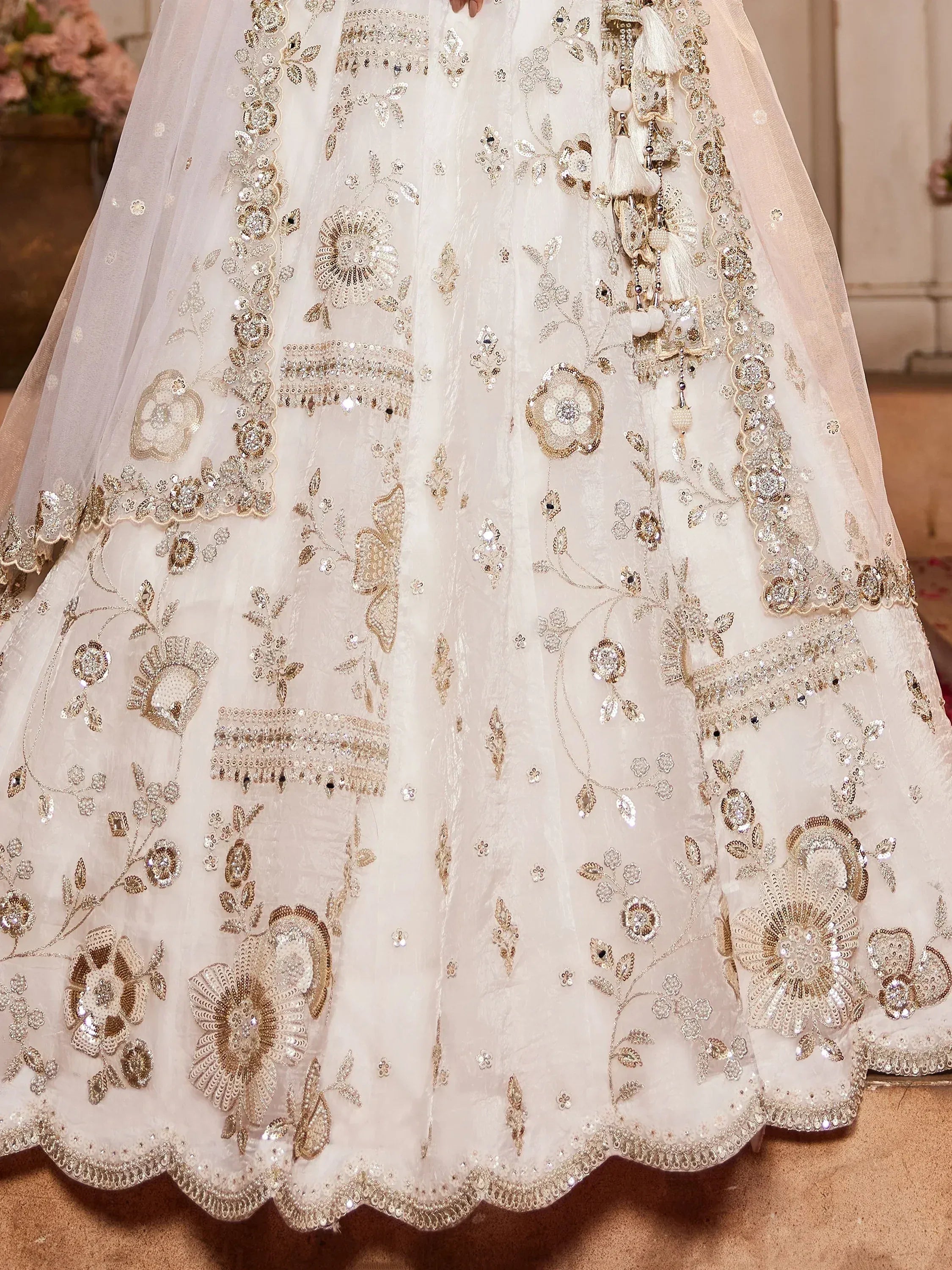 Elegant ivory lehenga with gold floral embroidery and sequin detailing for Indian ethnic wear