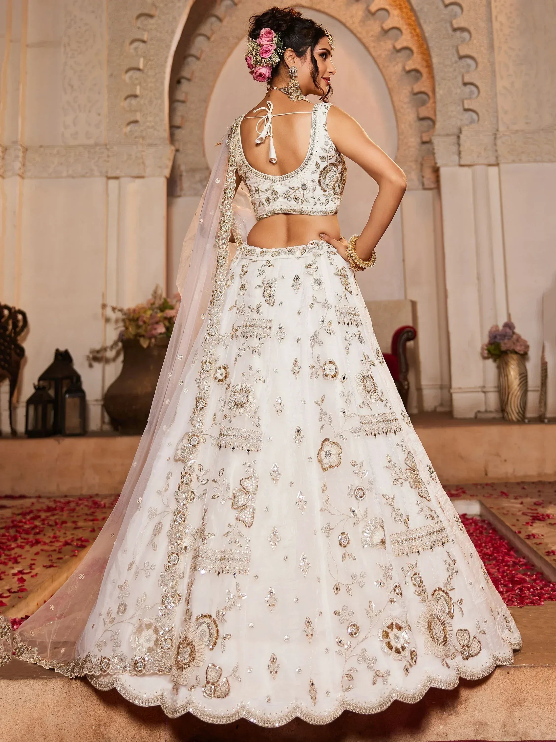 White embroidered lehenga choli with gold floral work, back view, perfect for Indian weddings and ethnic events