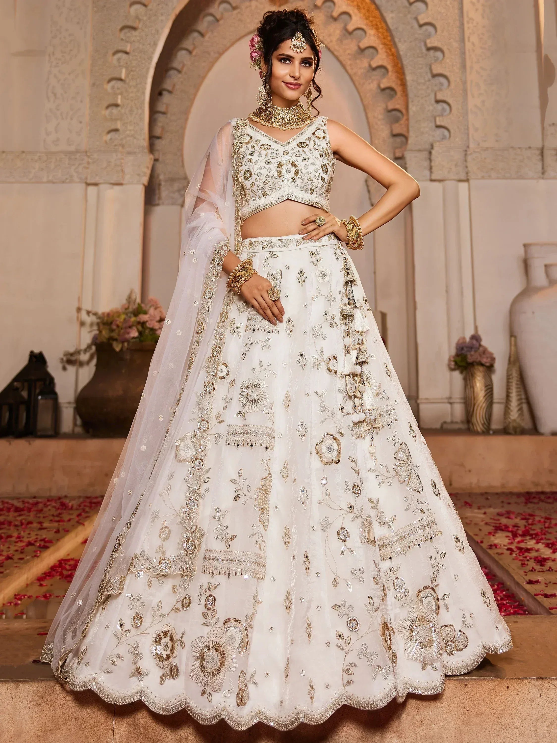 White embroidered lehenga choli with gold detailing, perfect for Indian weddings and ethnic events.