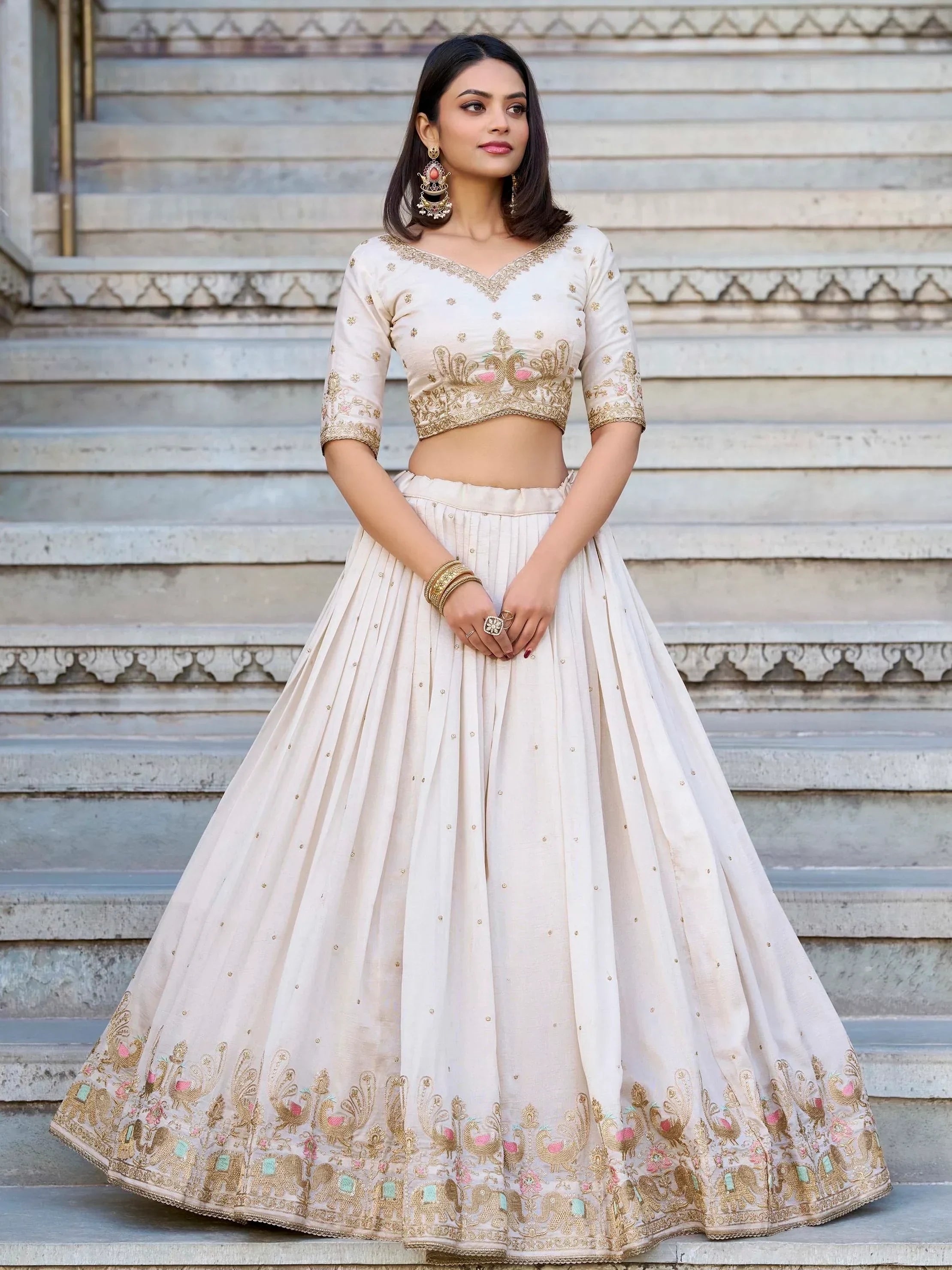 Cream embroidered lehenga choli with peacock design, perfect for Indian weddings and festive occasions.