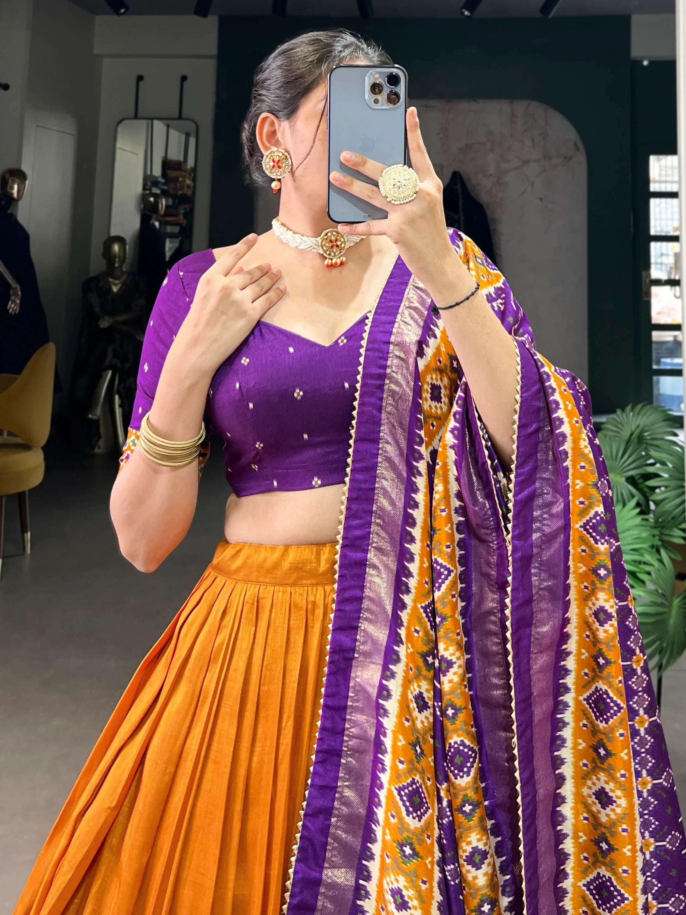 Purple and orange ethnic lehenga choli with patterned dupatta, traditional Indian wear