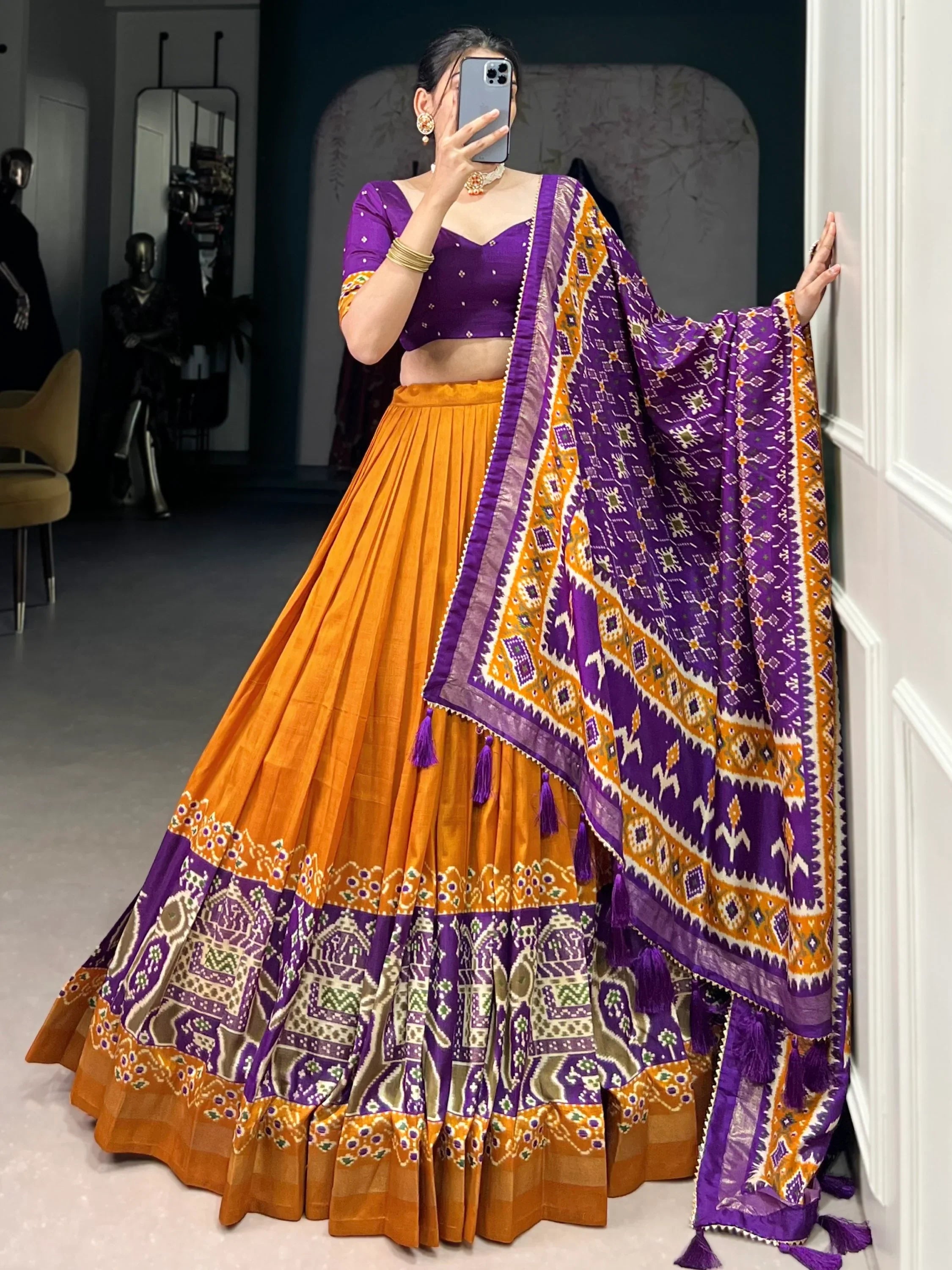 Purple and orange ethnic lehenga choli with printed dupatta, perfect for Indian weddings and festive occasions.