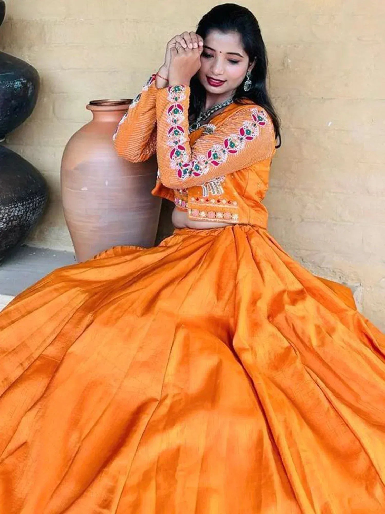 Orange embroidered lehenga choli with floral detailing, perfect for Indian ethnic wear occasions