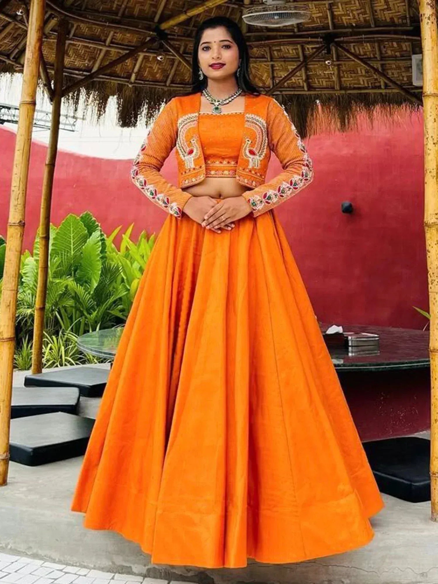 Vibrant orange lehenga choli with peacock embroidery, perfect for Indian ethnic occasions