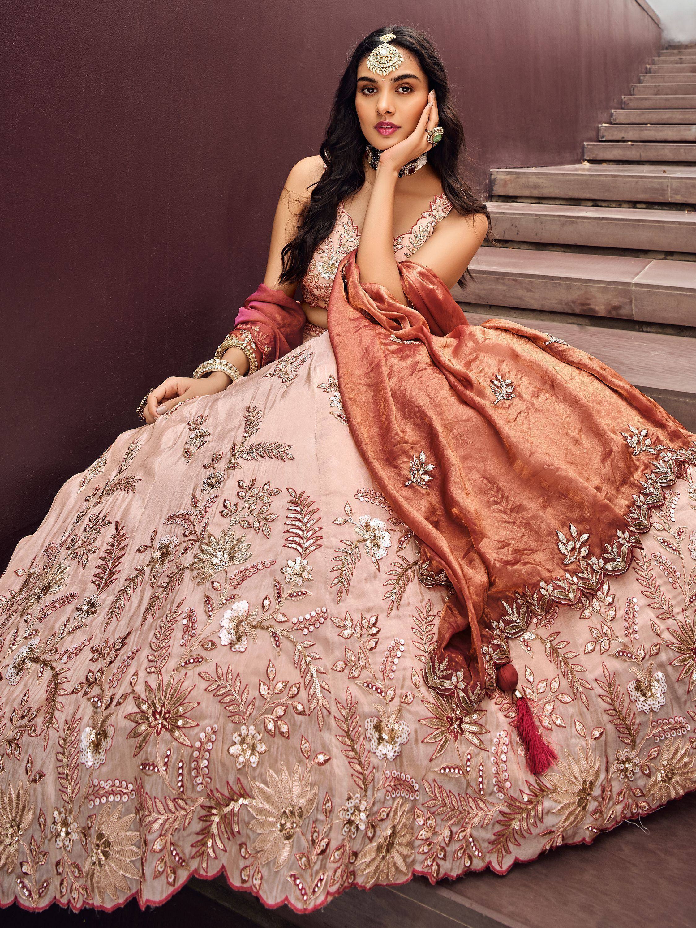 Elegant Indian designer lehenga choli with floral embroidery, perfect for weddings and festive occasions.