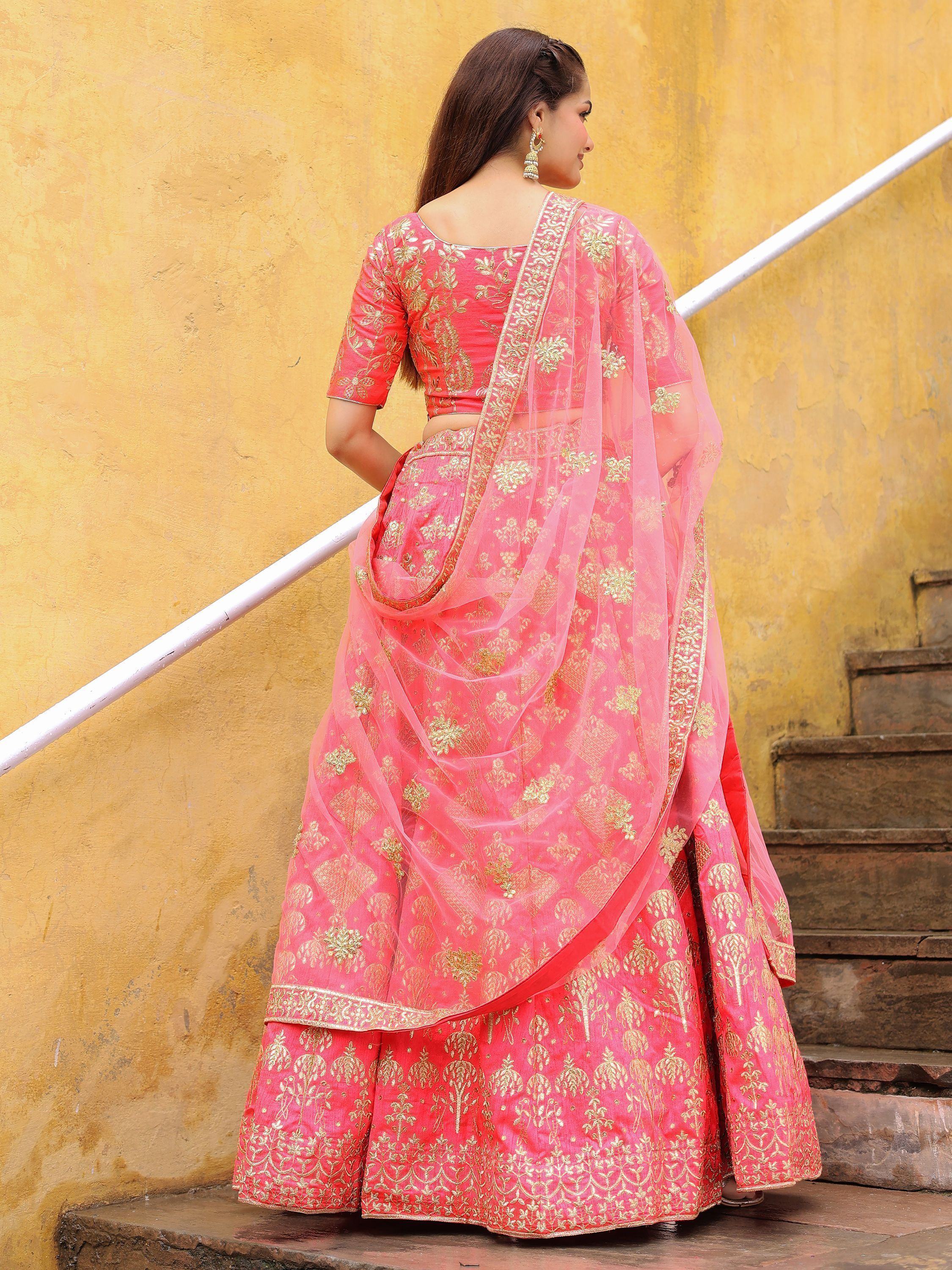 Pink designer lehenga choli with gold embroidery, perfect for Indian weddings and festive occasions.