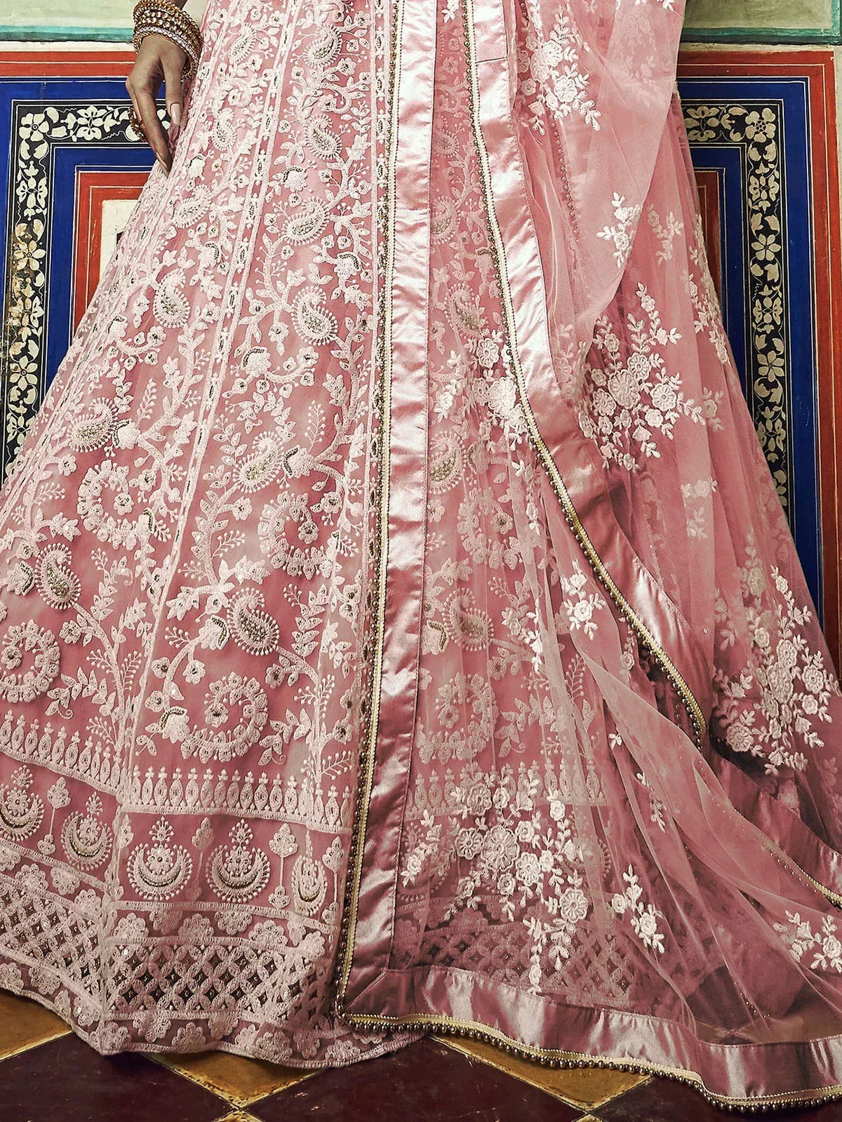 Pink embroidered lehenga choli with floral and paisley motifs, perfect for Indian ethnic wear occasions