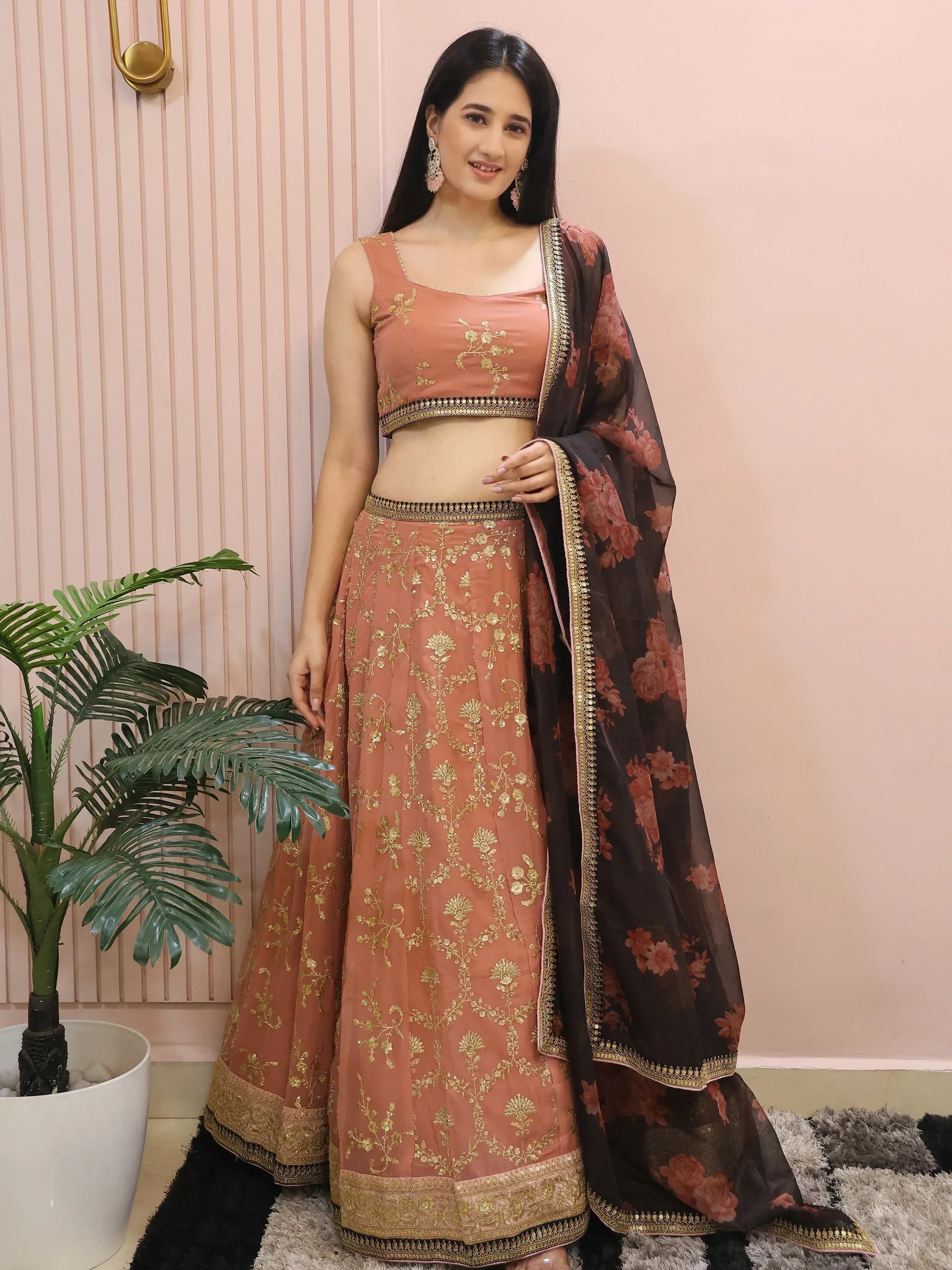 Woman in peach embroidered lehenga choli with floral dupatta, Indian ethnic wear