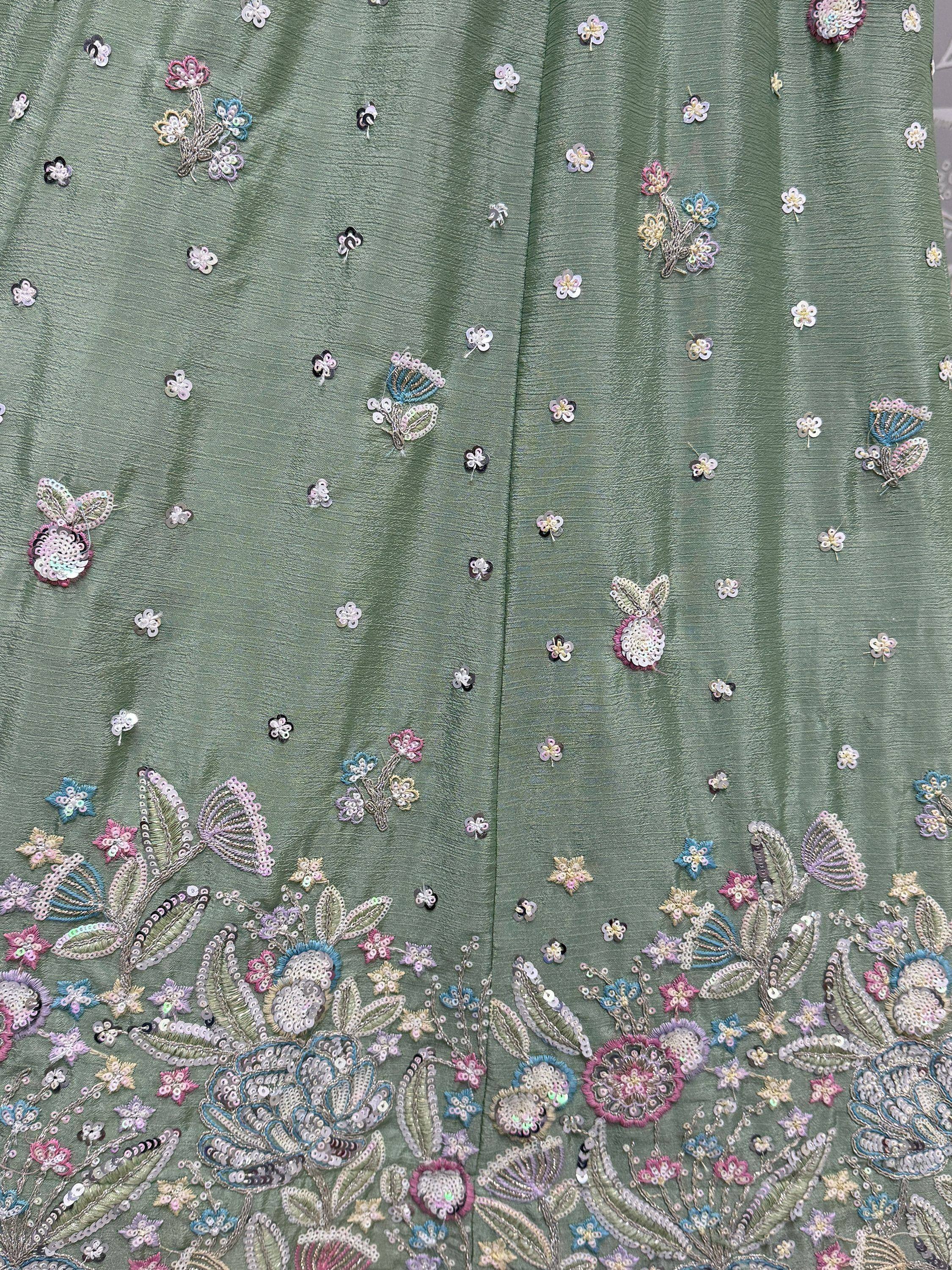 Green ethnic wear with floral embroidery and sequin details, perfect for Indian festive occasions