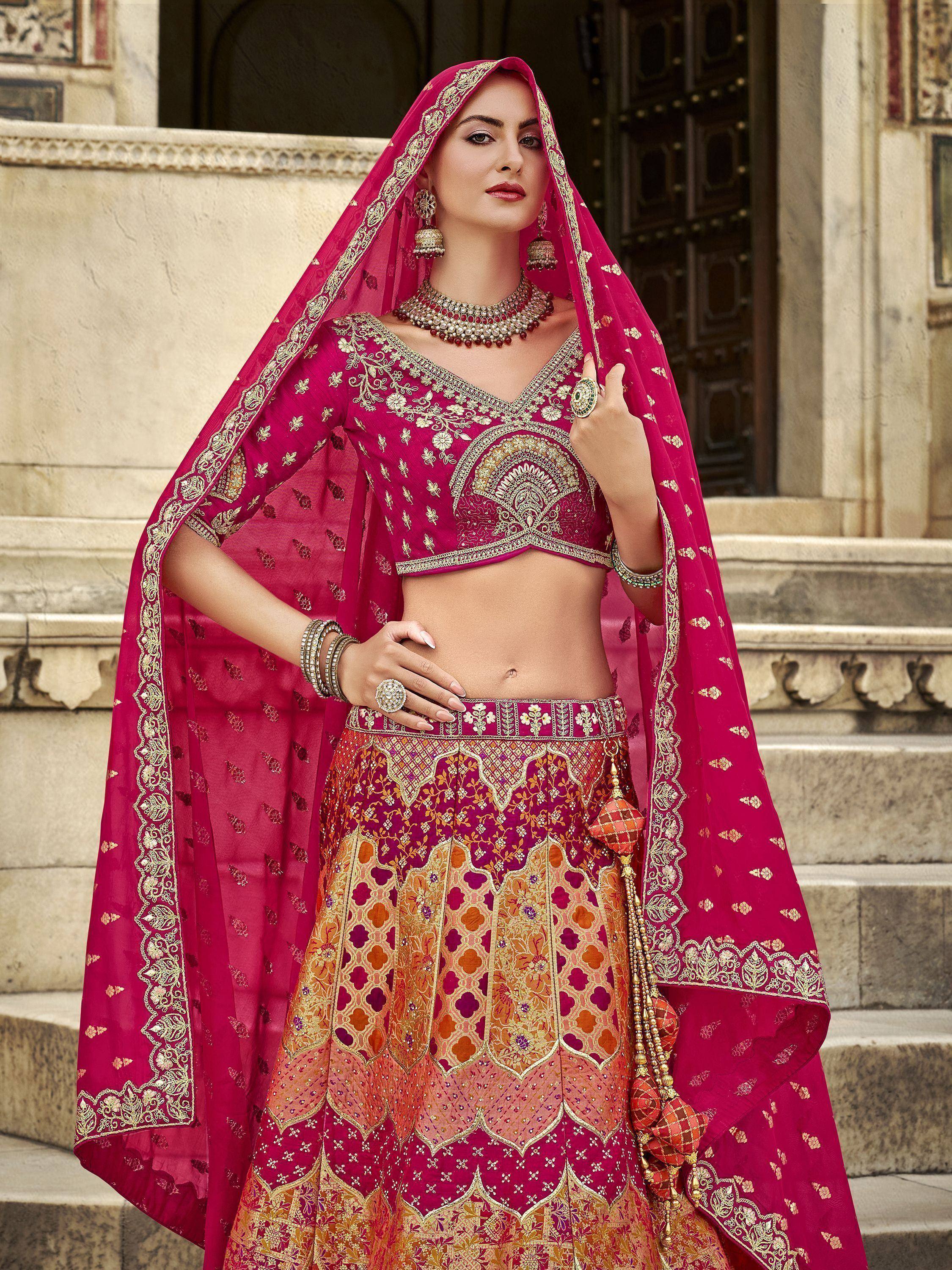 Fuchsia designer lehenga choli with gold embroidery, perfect for Indian weddings and ethnic events.