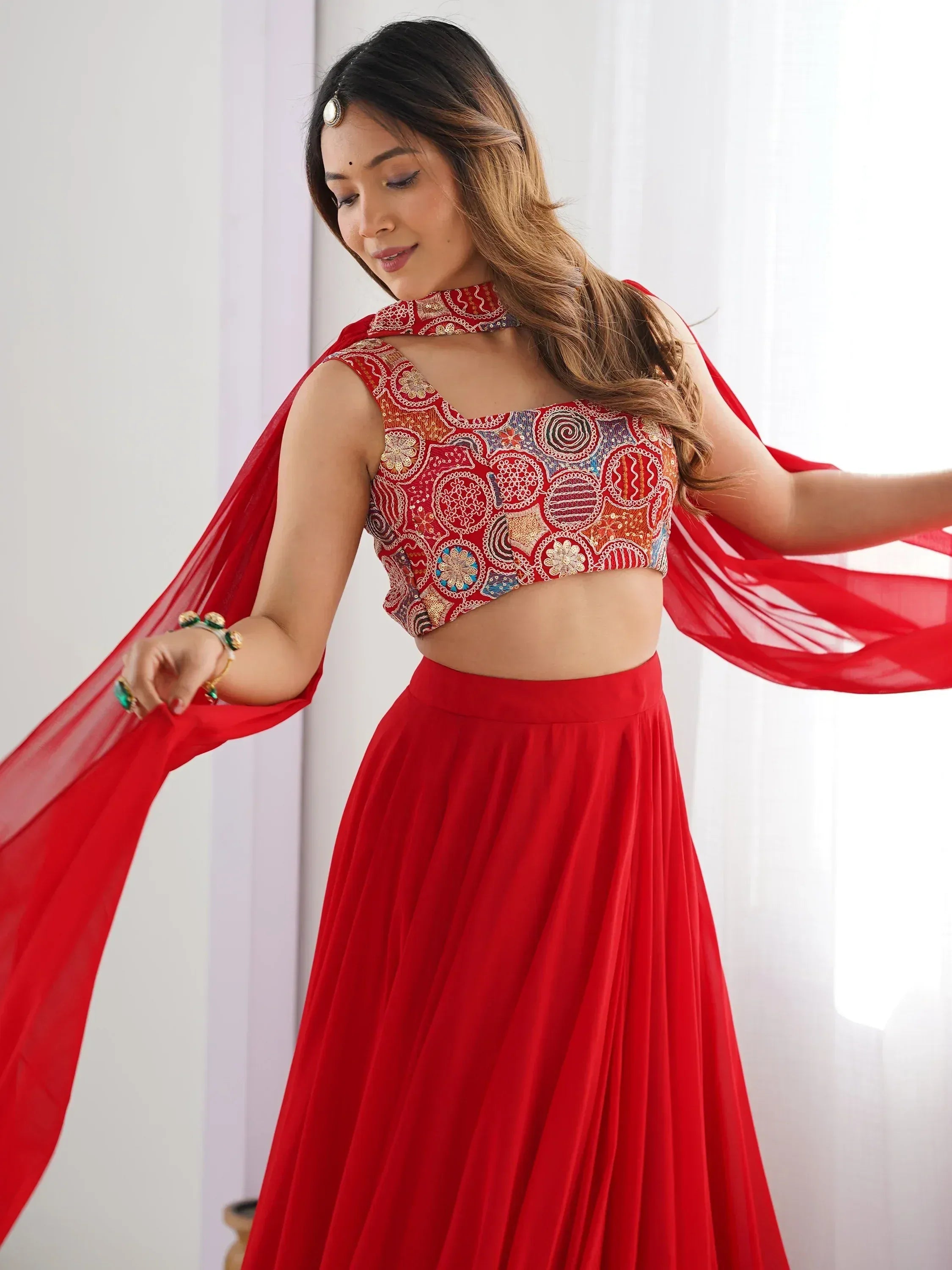 Red embroidered lehenga choli with flowing dupatta, perfect for Indian ethnic wear occasions
