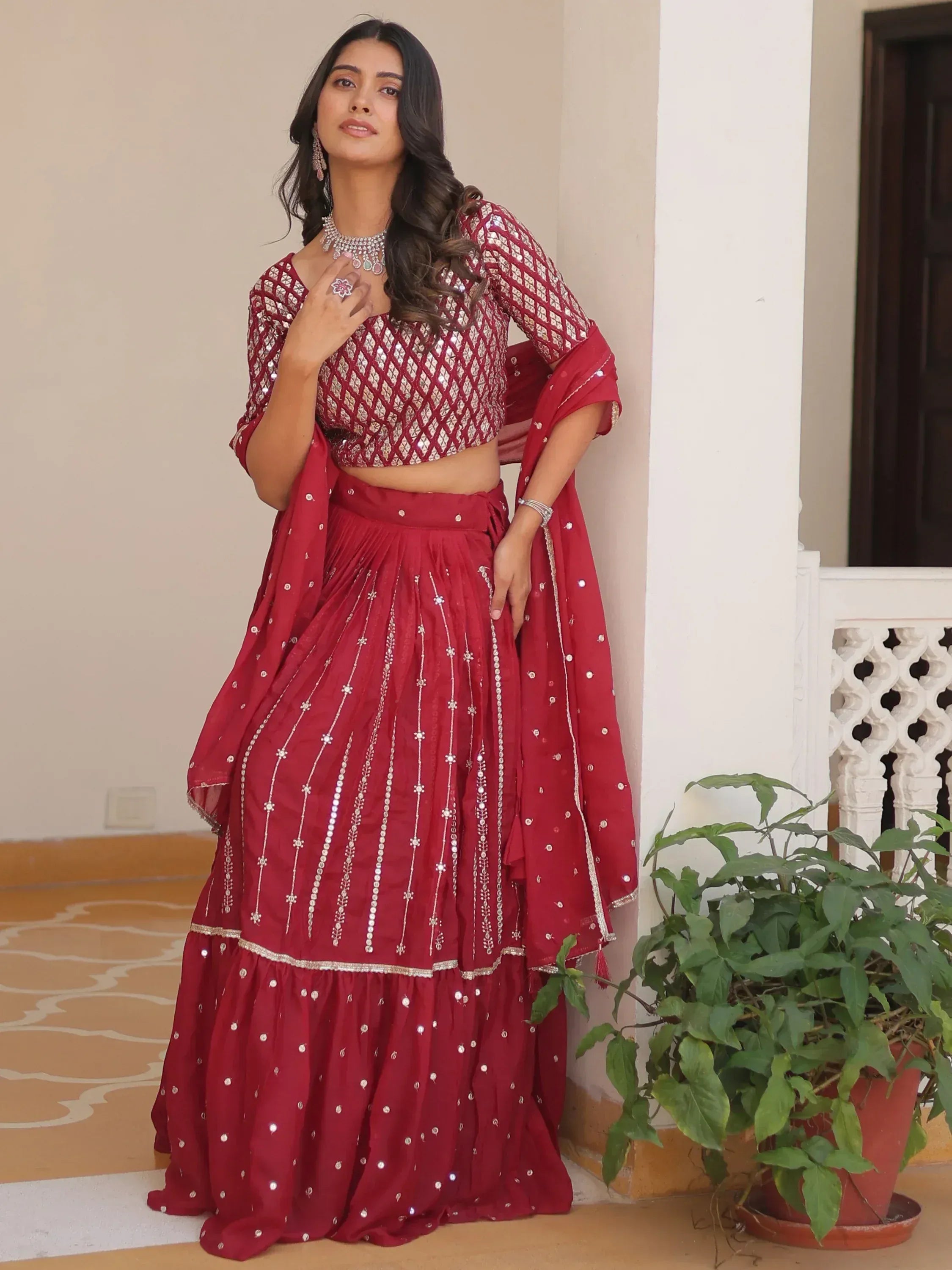 Red designer lehenga choli with mirror work, perfect for Indian ethnic wear and festive occasions