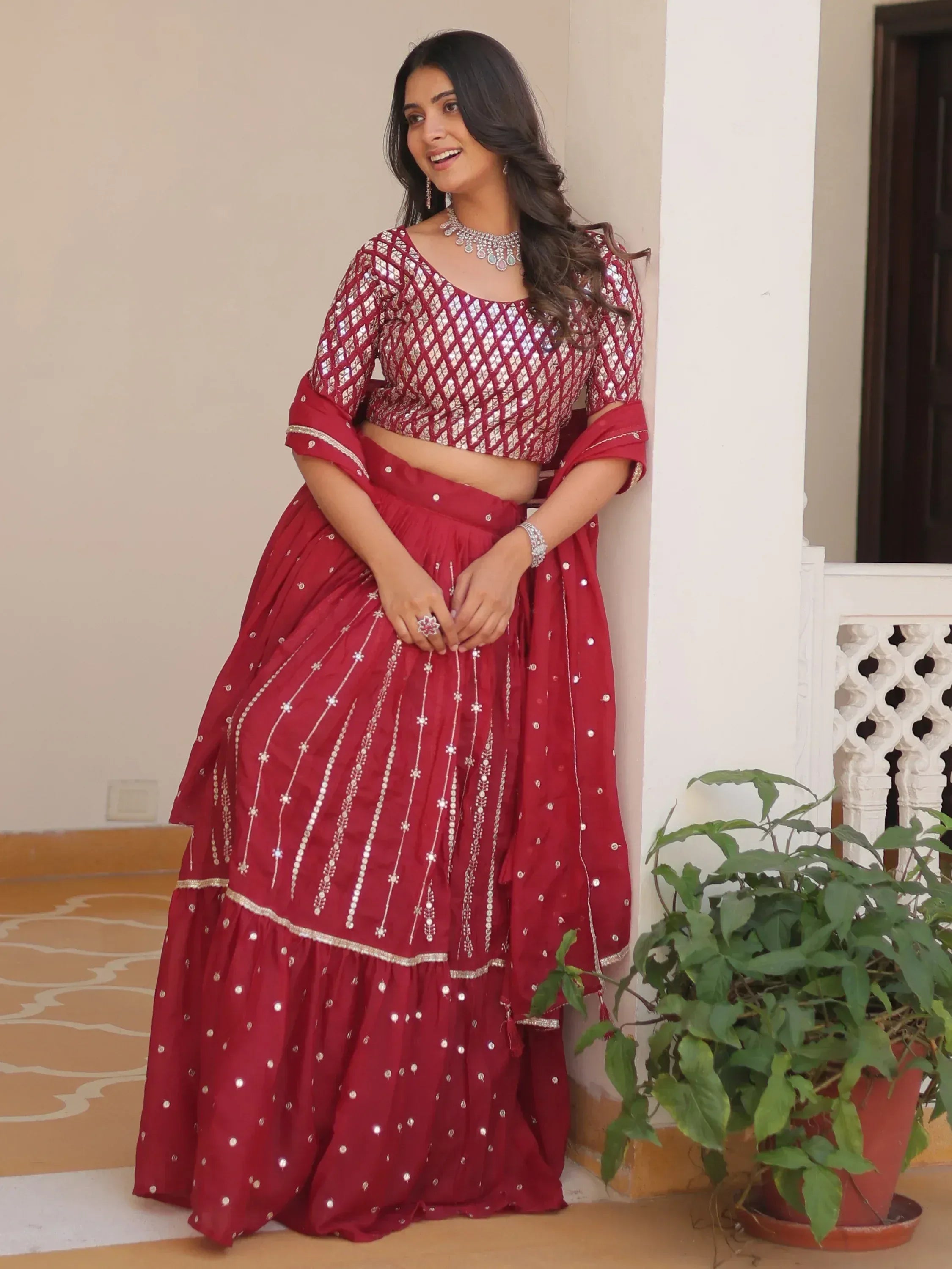 Red designer lehenga choli with mirror work, perfect for Indian ethnic wear and festive occasions