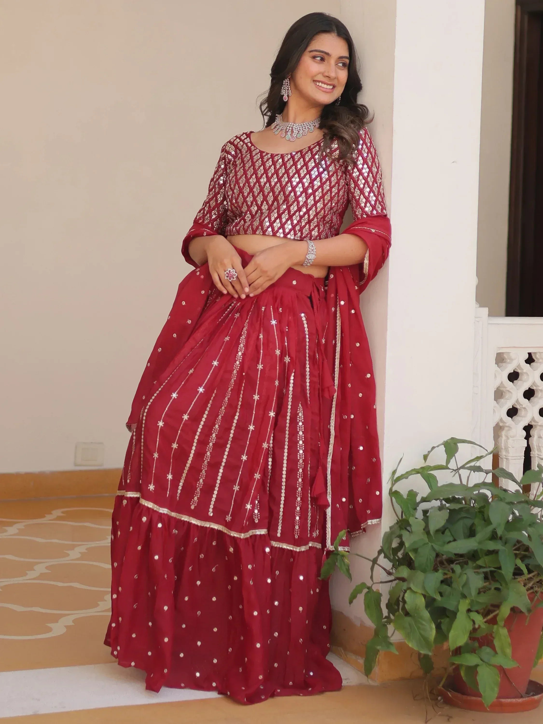 Red sequin lehenga choli with gold embroidery, perfect for Indian weddings and festive occasions.