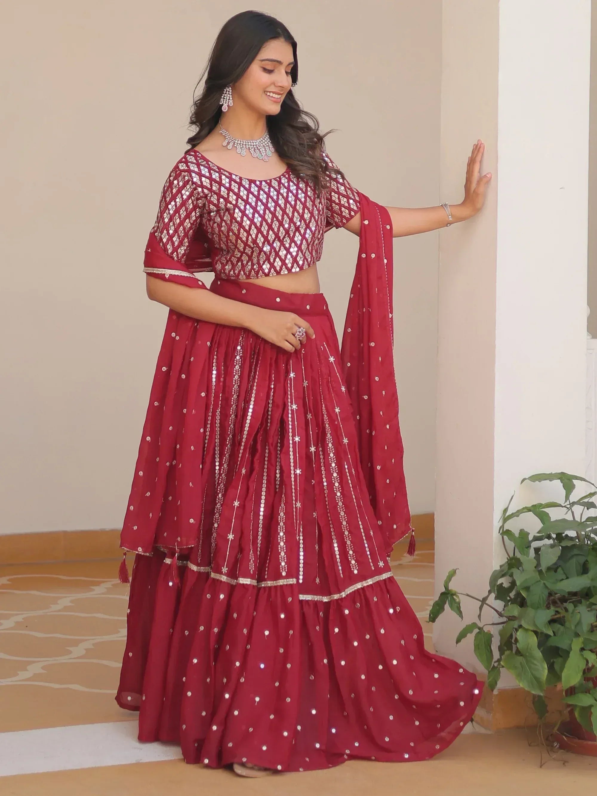 Red designer lehenga choli with mirror work and embroidery, perfect for Indian ethnic wear occasions