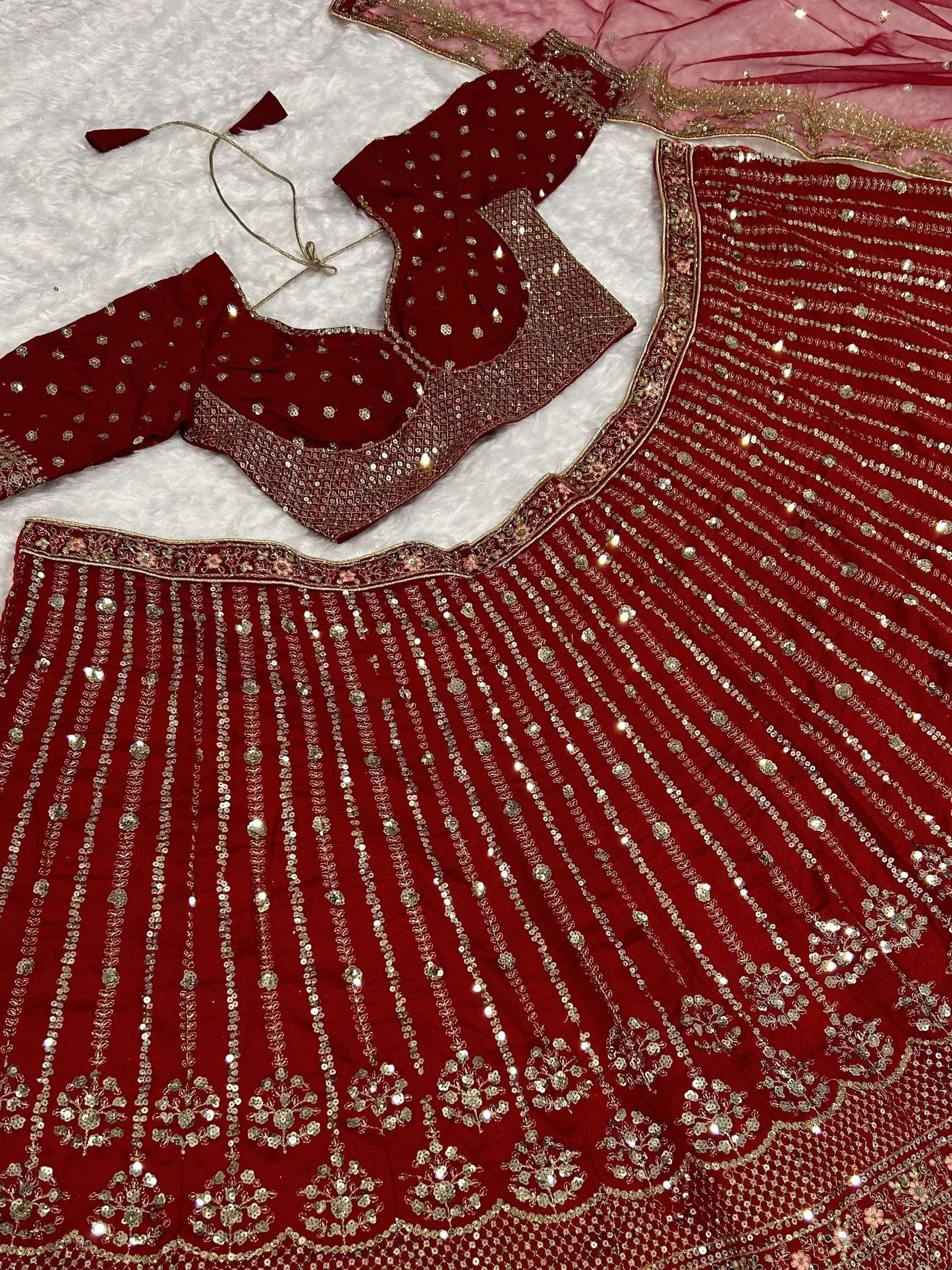 Red velvet lehenga choli with gold sequin embroidery, perfect for Indian weddings and festive occasions.