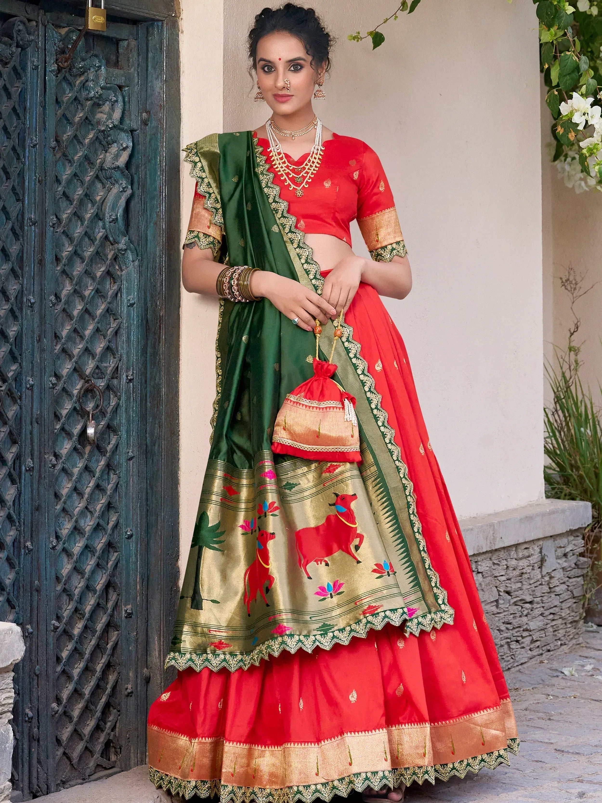 Red and green designer lehenga choli with bull print, gold embroidery, and matching dupatta for Indian ethnic wear