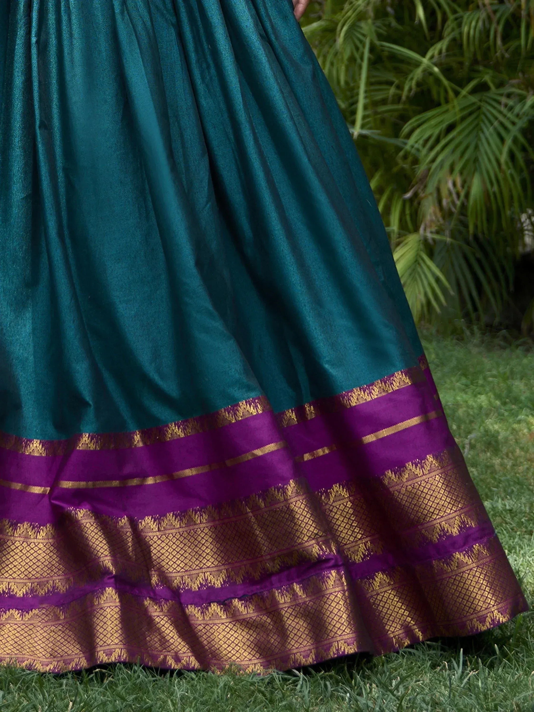 Teal and purple Indian ethnic skirt with gold woven border, styled for traditional wear