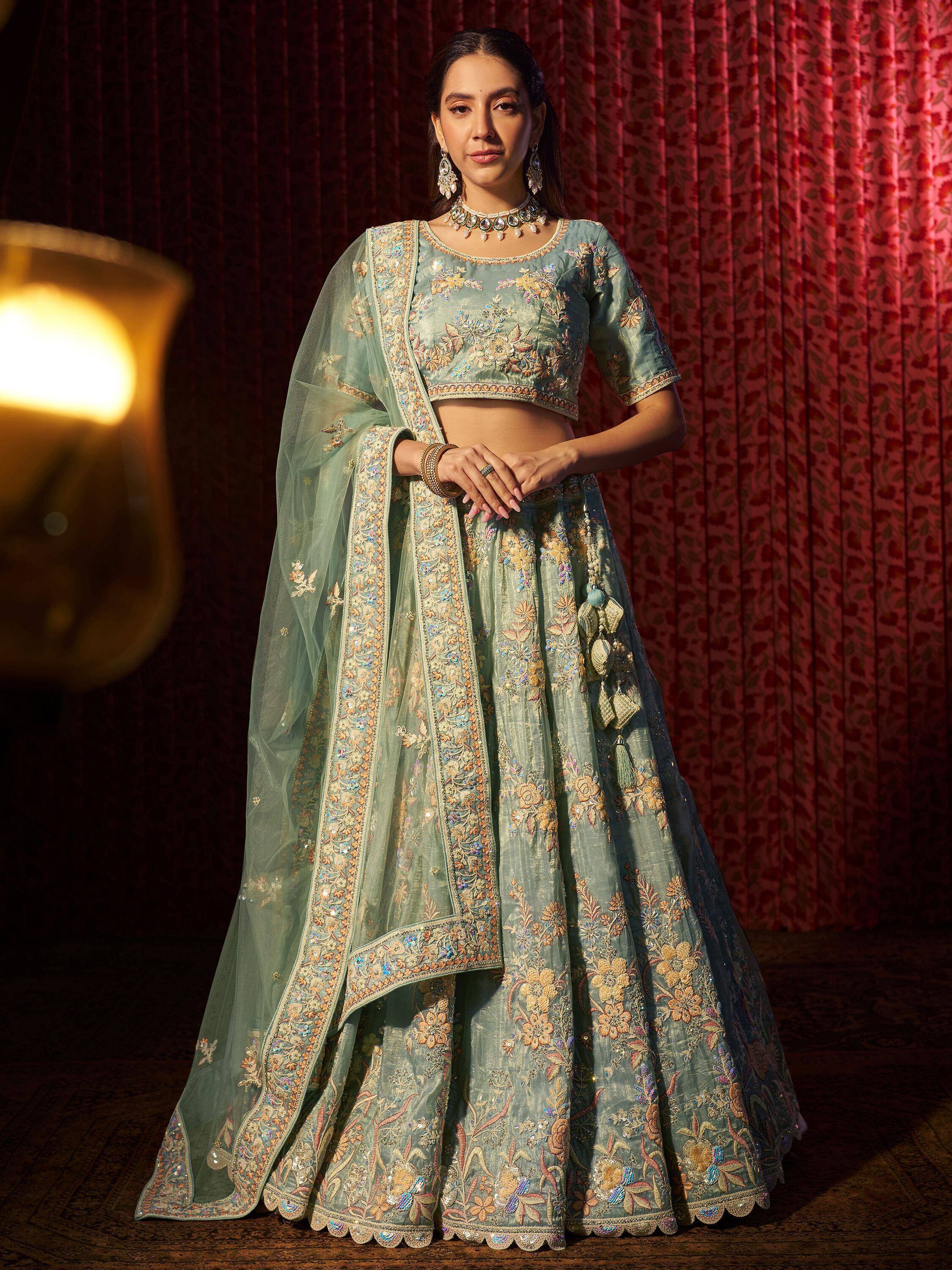 Mint green embroidered lehenga choli with floral motifs and sheer dupatta, perfect for Indian weddings and festive occasions.