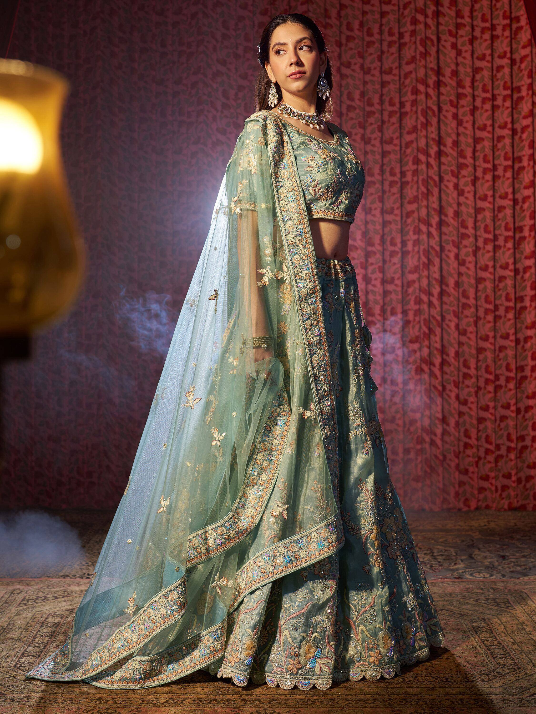 Elegant mint green designer lehenga choli with floral embroidery and sheer dupatta, perfect for Indian ethnic wear.