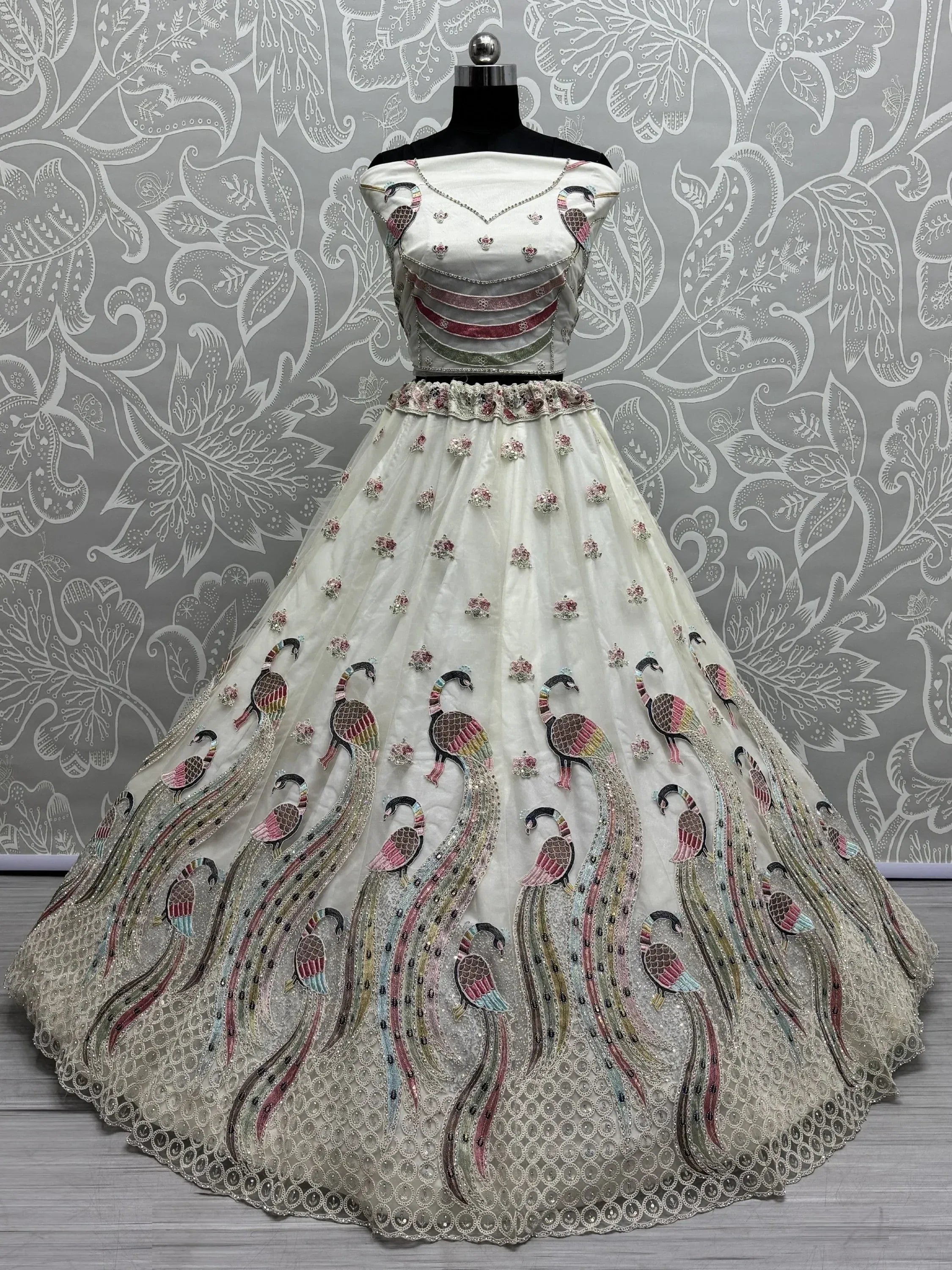 White designer lehenga with peacock embroidery, perfect for Indian weddings and ethnic events.