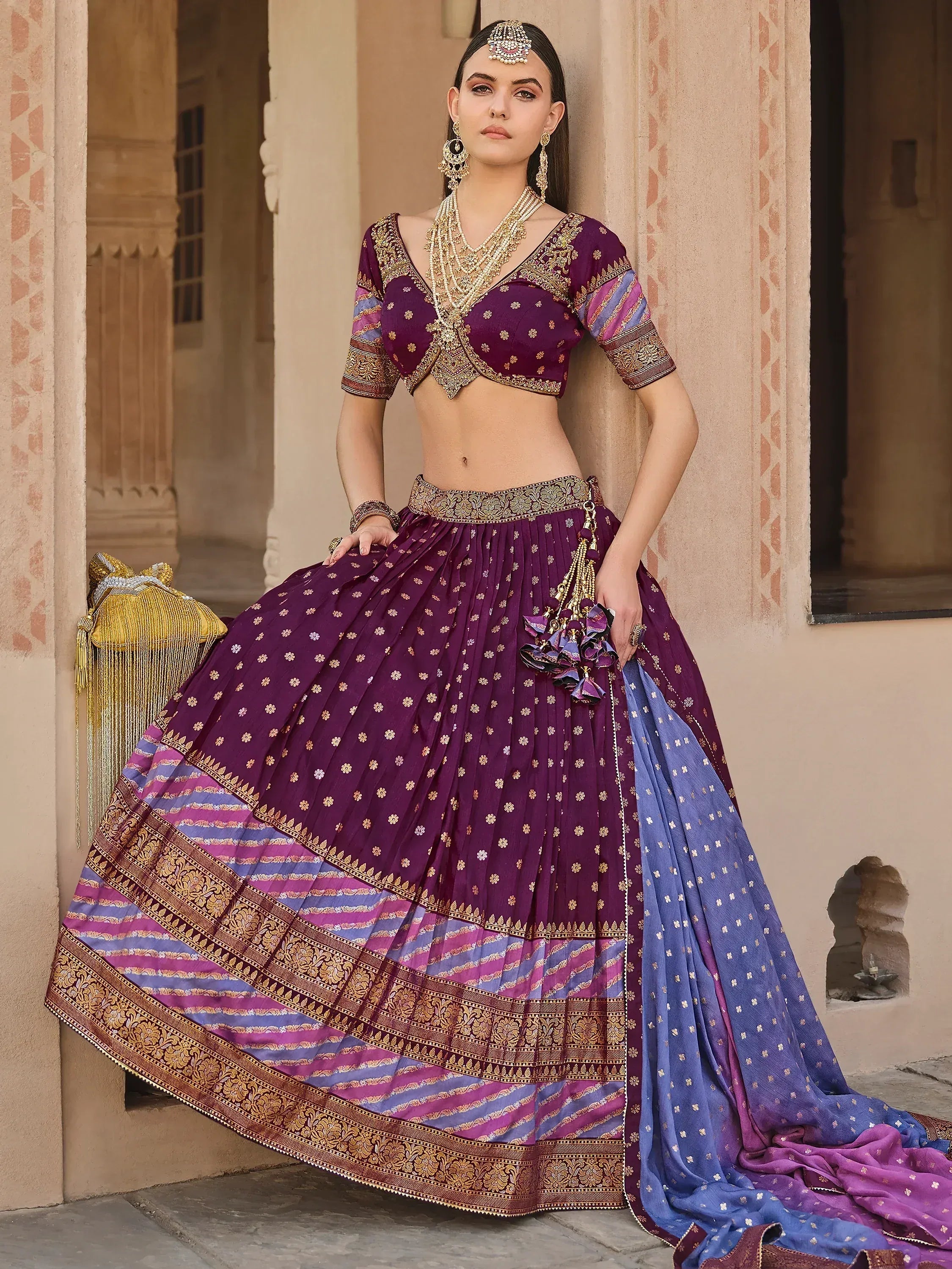 Purple and blue designer lehenga choli with gold embroidery, perfect for Indian weddings and festive occasions.
