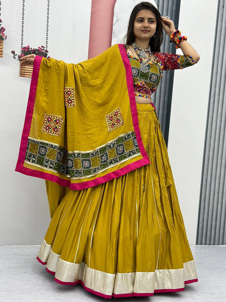 Mustard yellow embroidered lehenga choli with mirror work and pink border, perfect for Indian ethnic wear
