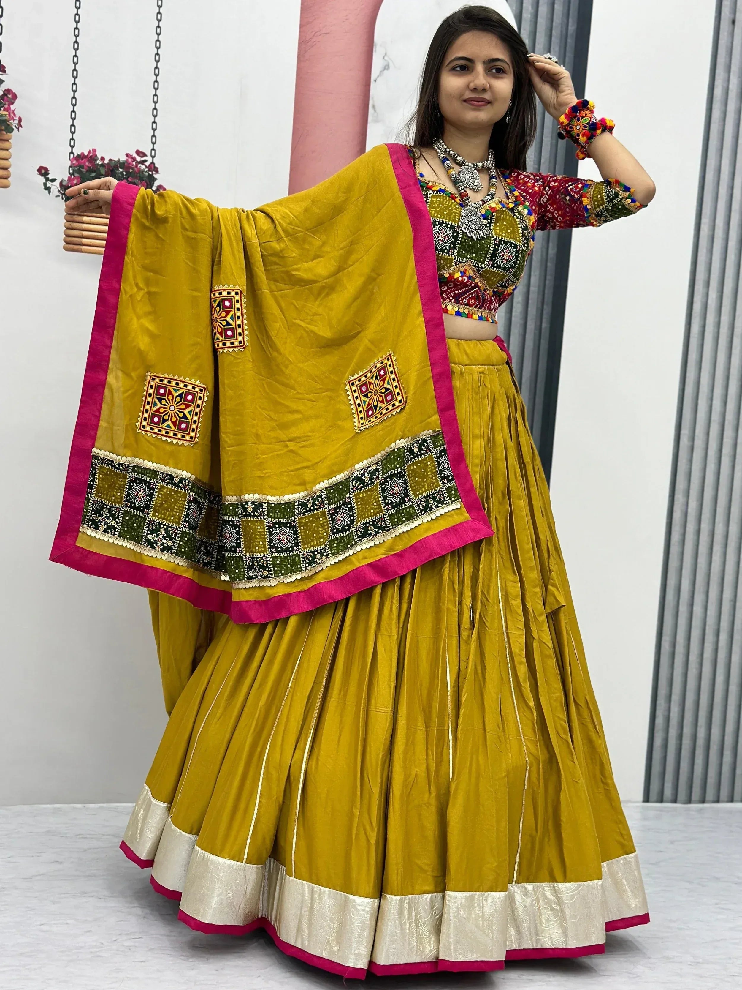 Mustard yellow embroidered lehenga choli with mirror work and pink border, perfect for Indian ethnic wear