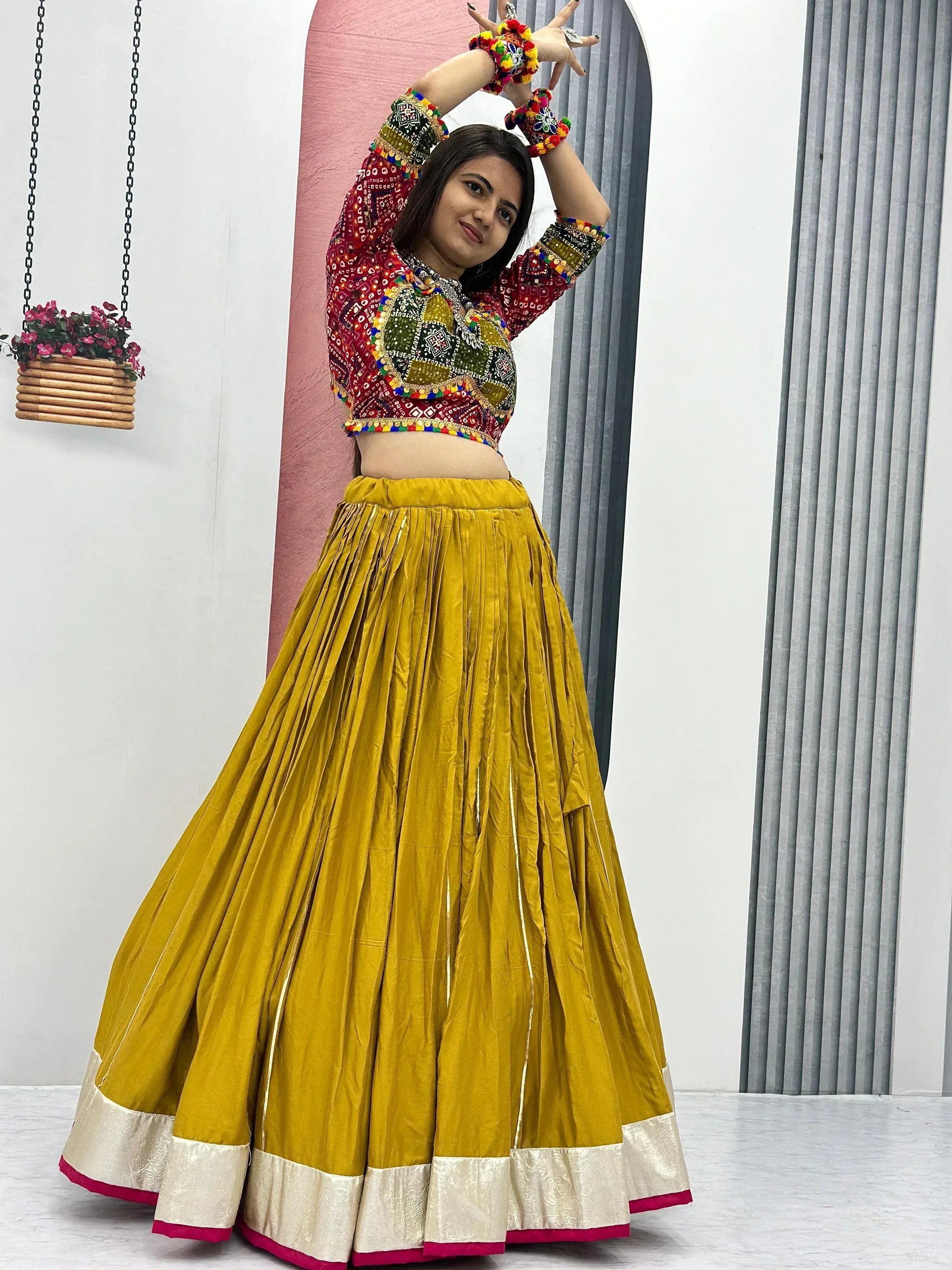 Woman in vibrant Indian ethnic lehenga choli with mirror work, mustard skirt, and colorful blouse for festive occasions