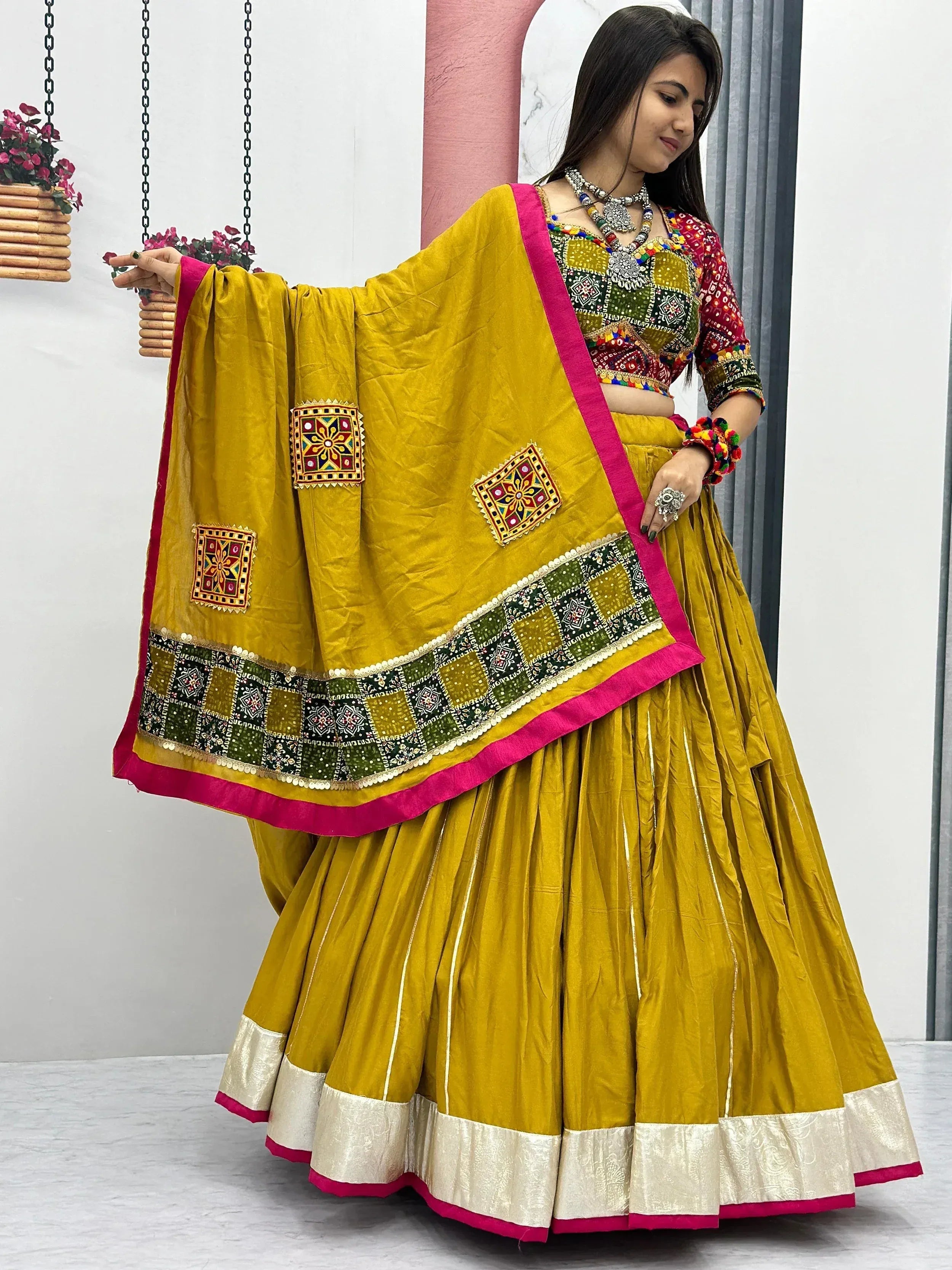 Yellow embroidered lehenga choli with mirror work and pink border, Indian ethnic wear