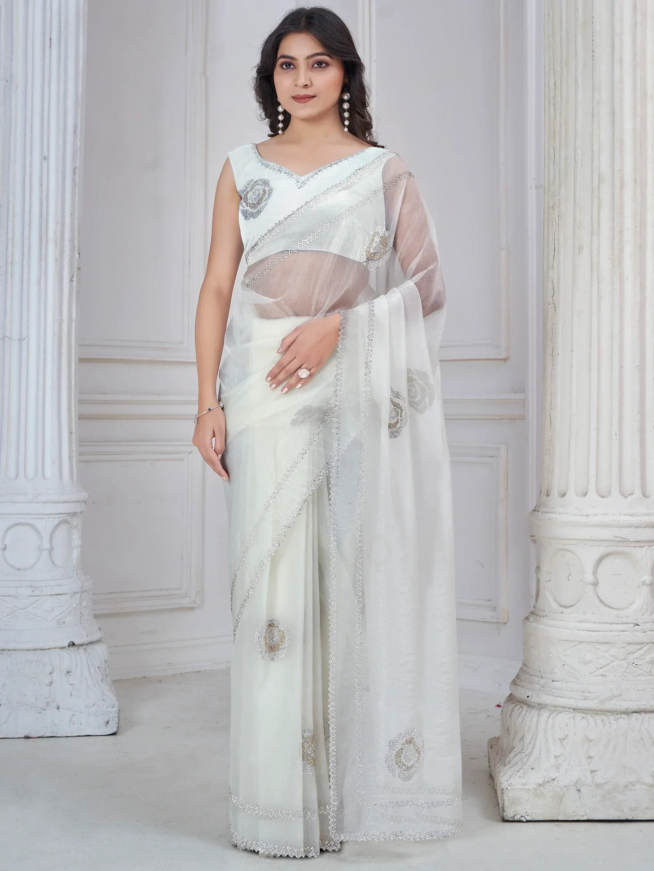 Elegant white saree with silver floral embroidery and sheer blouse, perfect for Indian ethnic occasions.