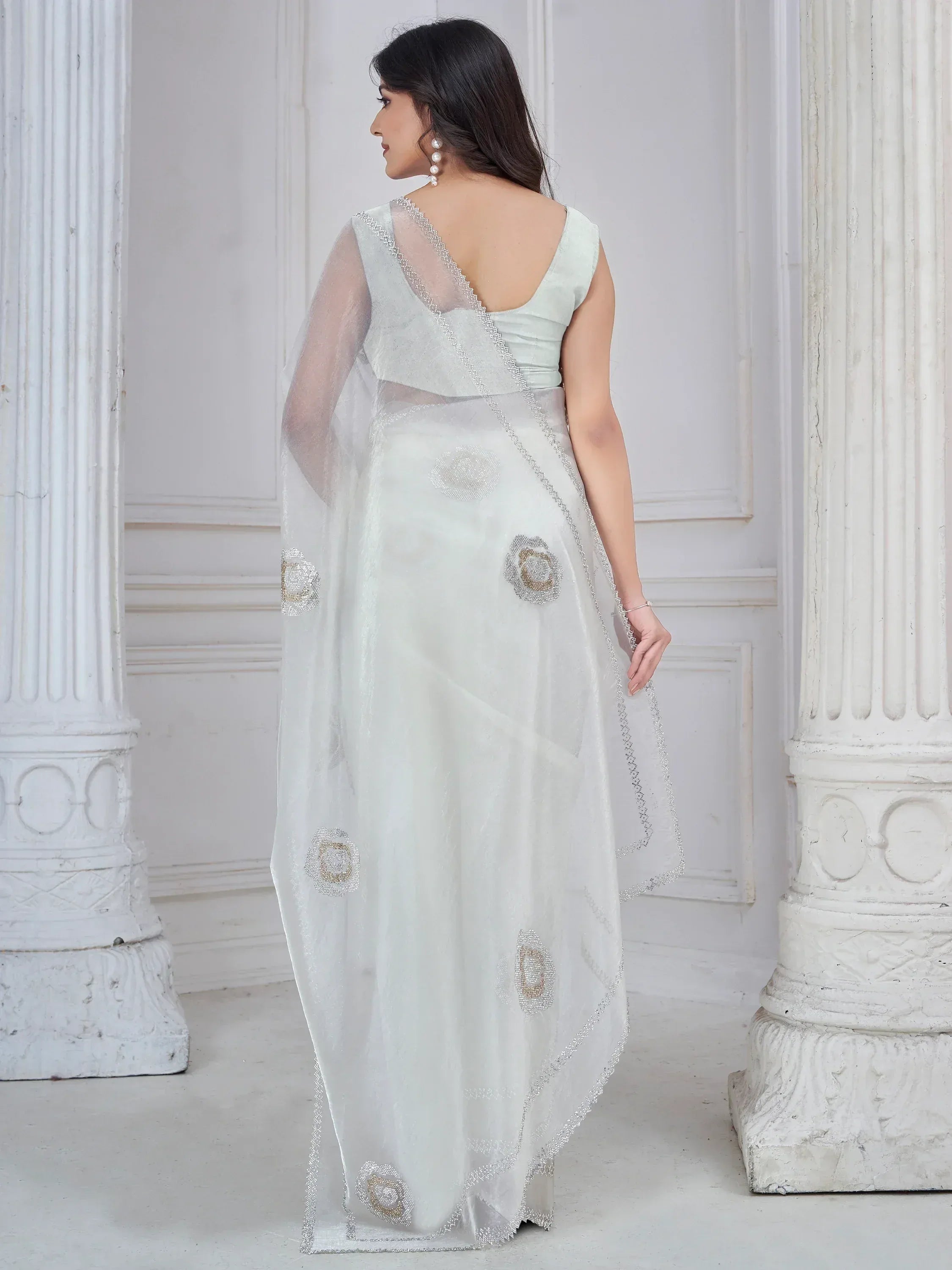 Elegant white saree with floral beadwork and sheer pallu, perfect for Indian ethnic occasions
