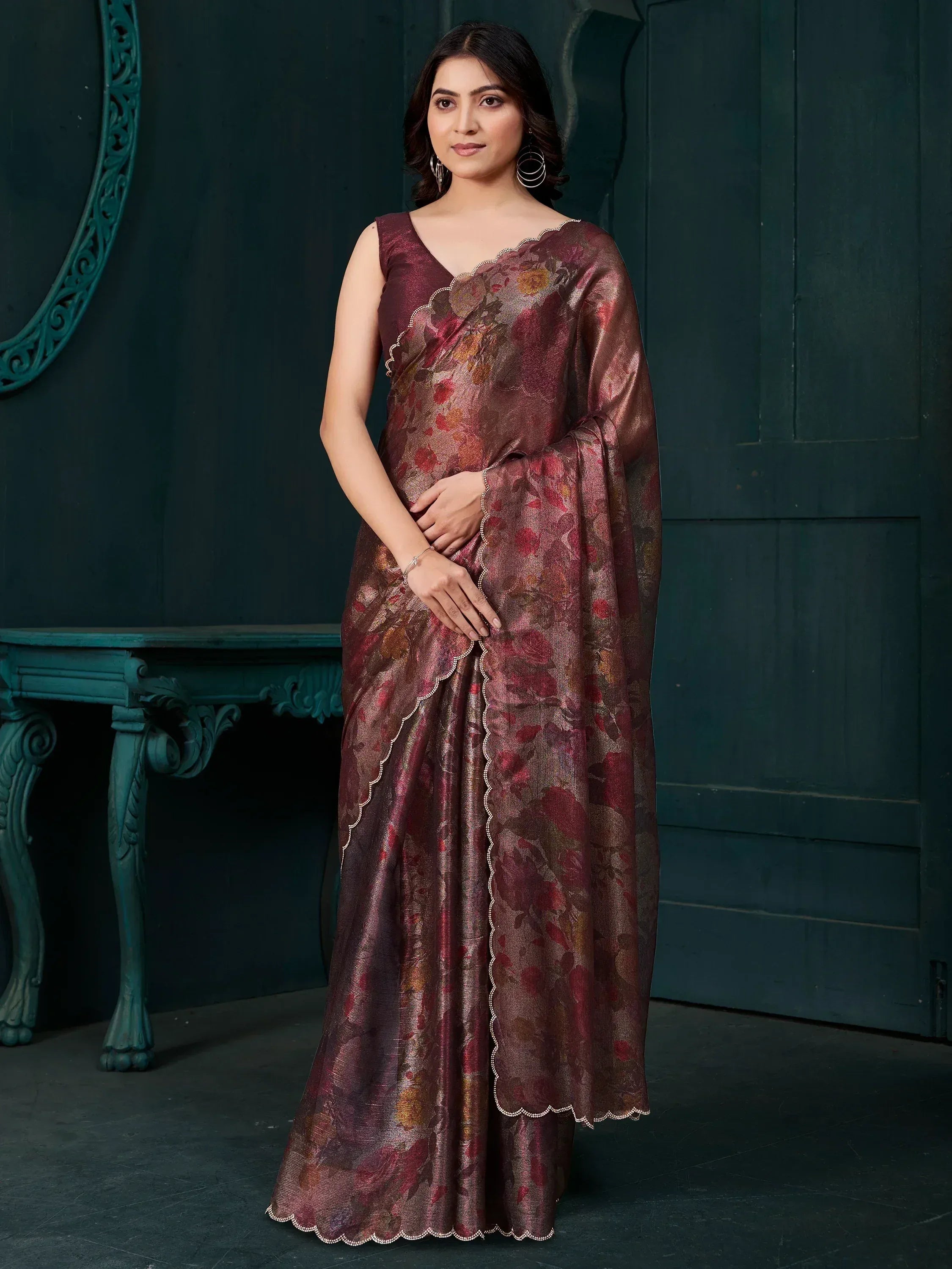 Woman in maroon floral saree with scalloped border, Indian ethnic wear for festive occasions