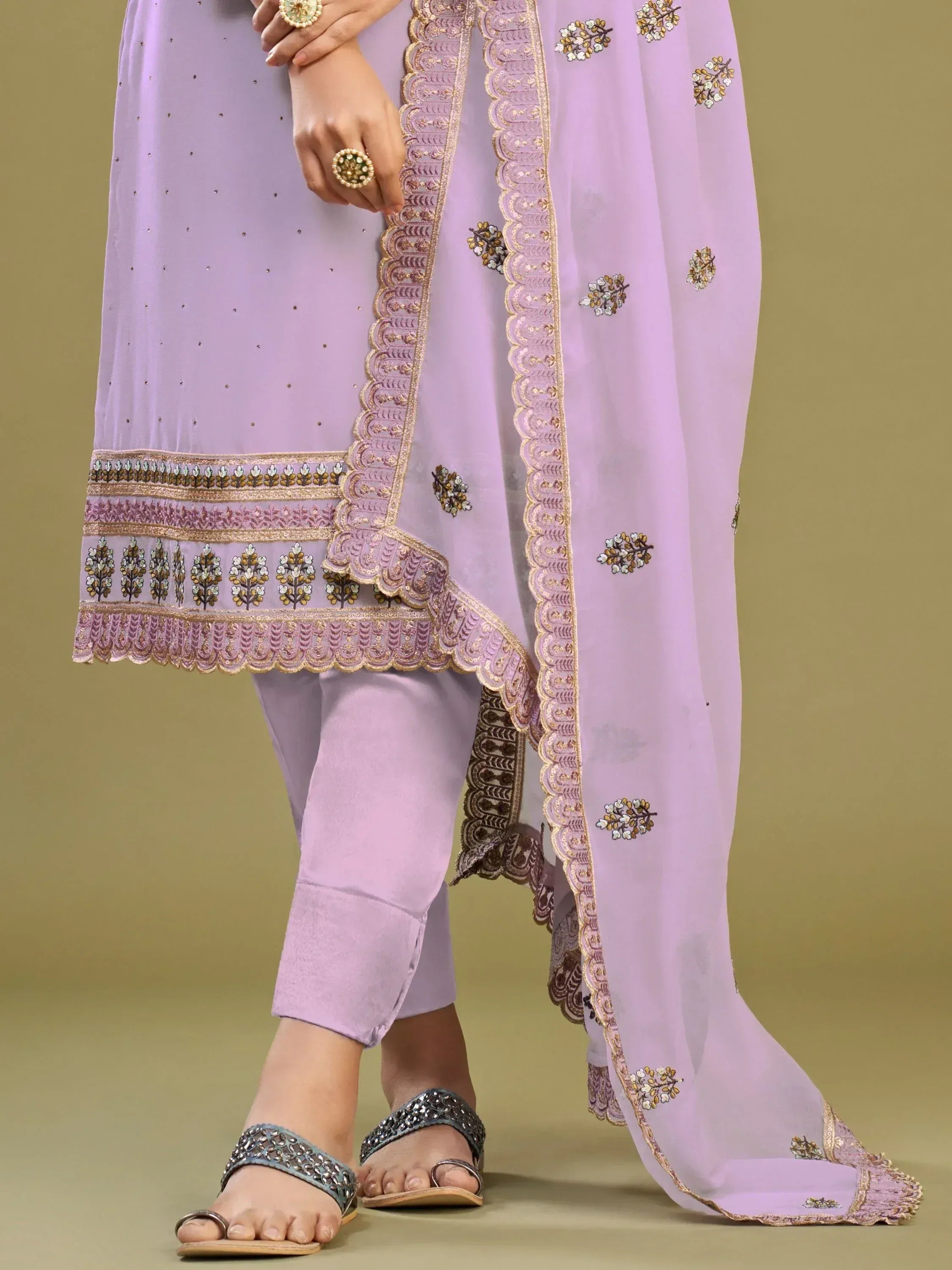 Lavender ethnic salwar kameez with floral embroidery and gold trim, perfect for Indian festive wear.