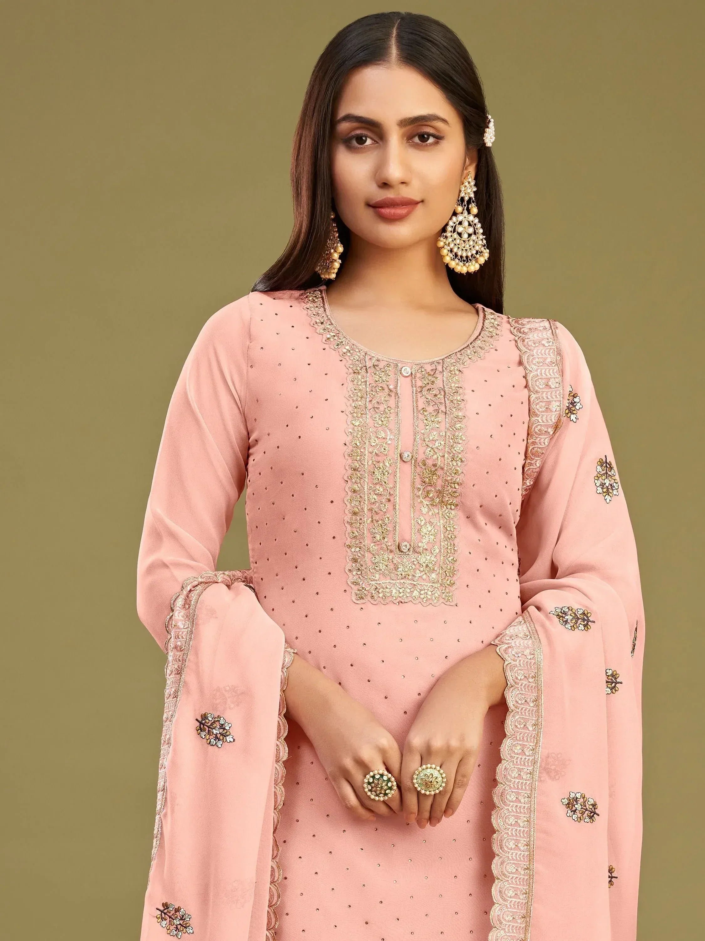 Pink embroidered ethnic kurti with gold detailing and floral motifs, perfect for festive occasions.
