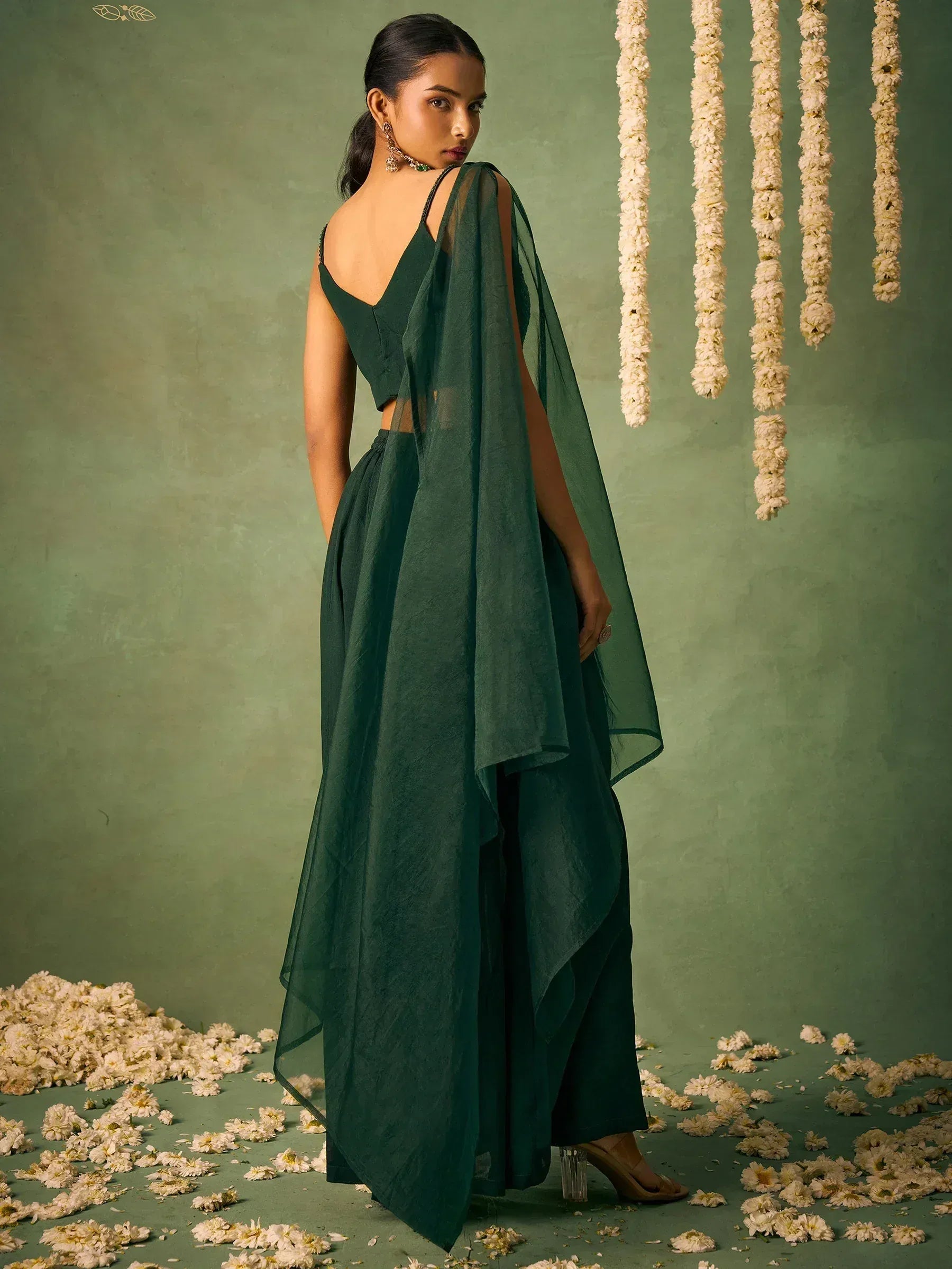 Emerald green ethnic gown with sheer drape, perfect for Indian weddings and festive occasions.