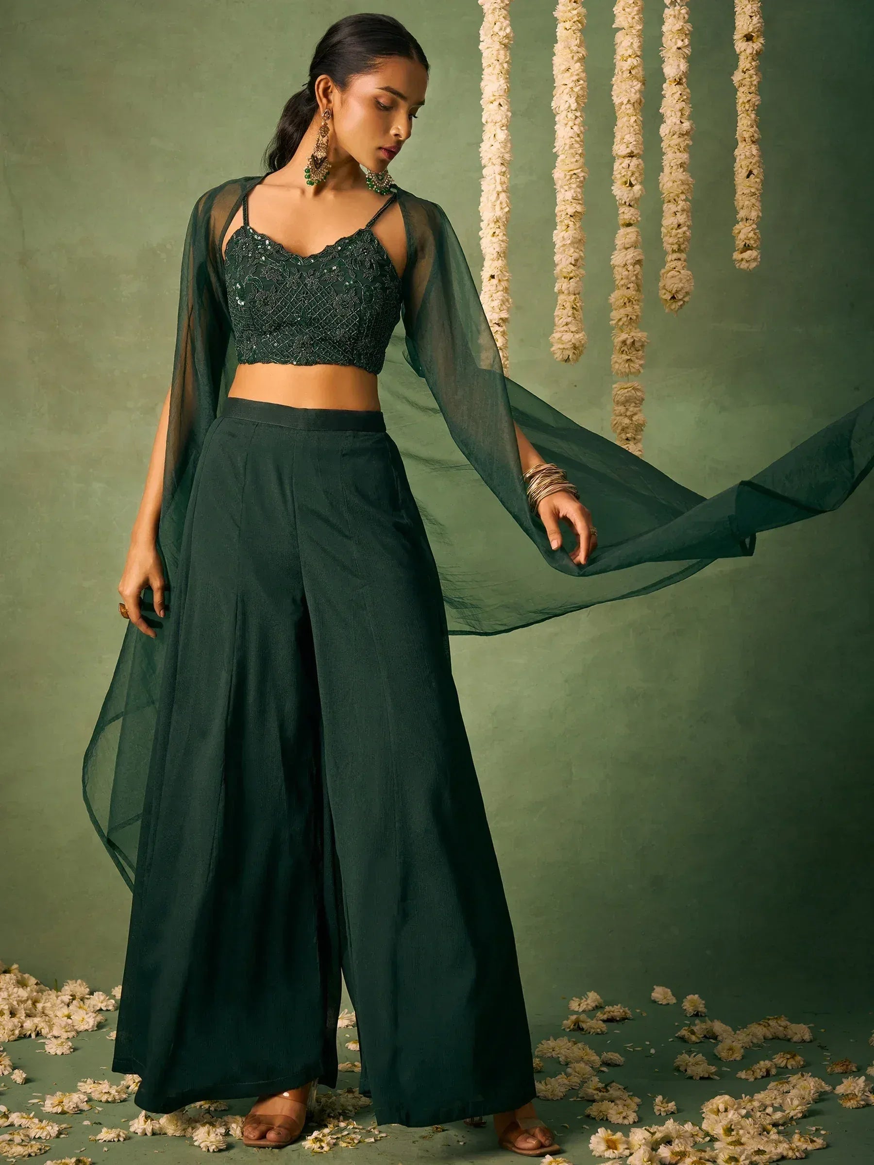 Emerald green ethnic palazzo set with sequin crop top and sheer cape, perfect for Indian occasions